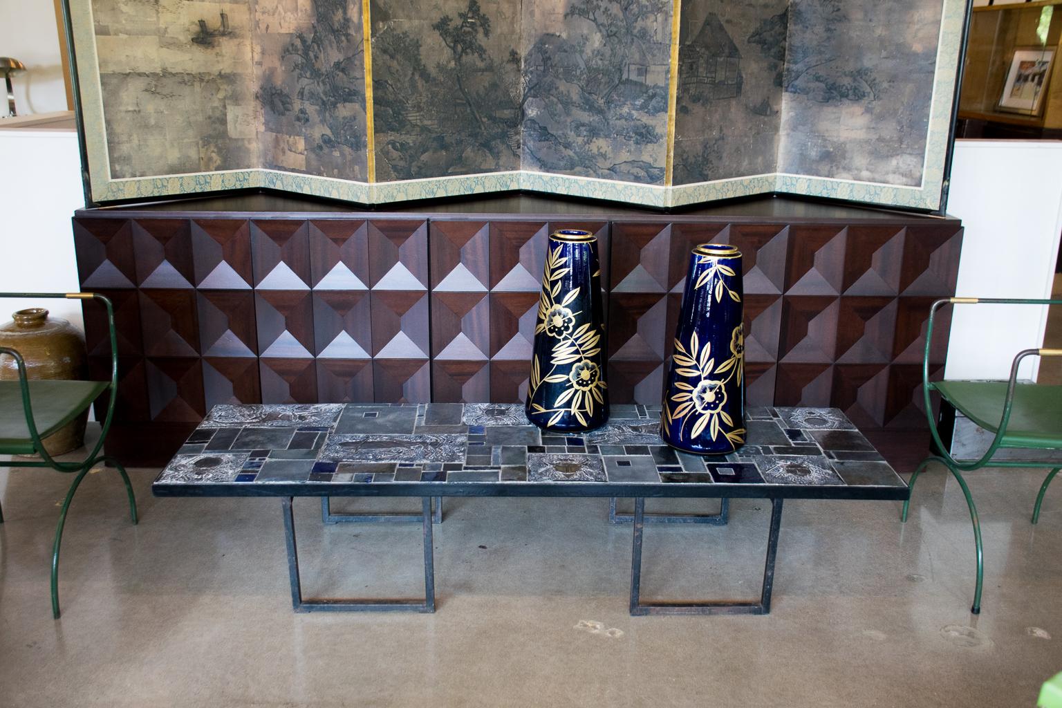 Midcentury sideboard by De Coene with rich chocolate stain over geometrically patterned doors. Brutalist styling characteristic of Belgian designers. Interior has adjustable shelves and two drawers, 1960s.