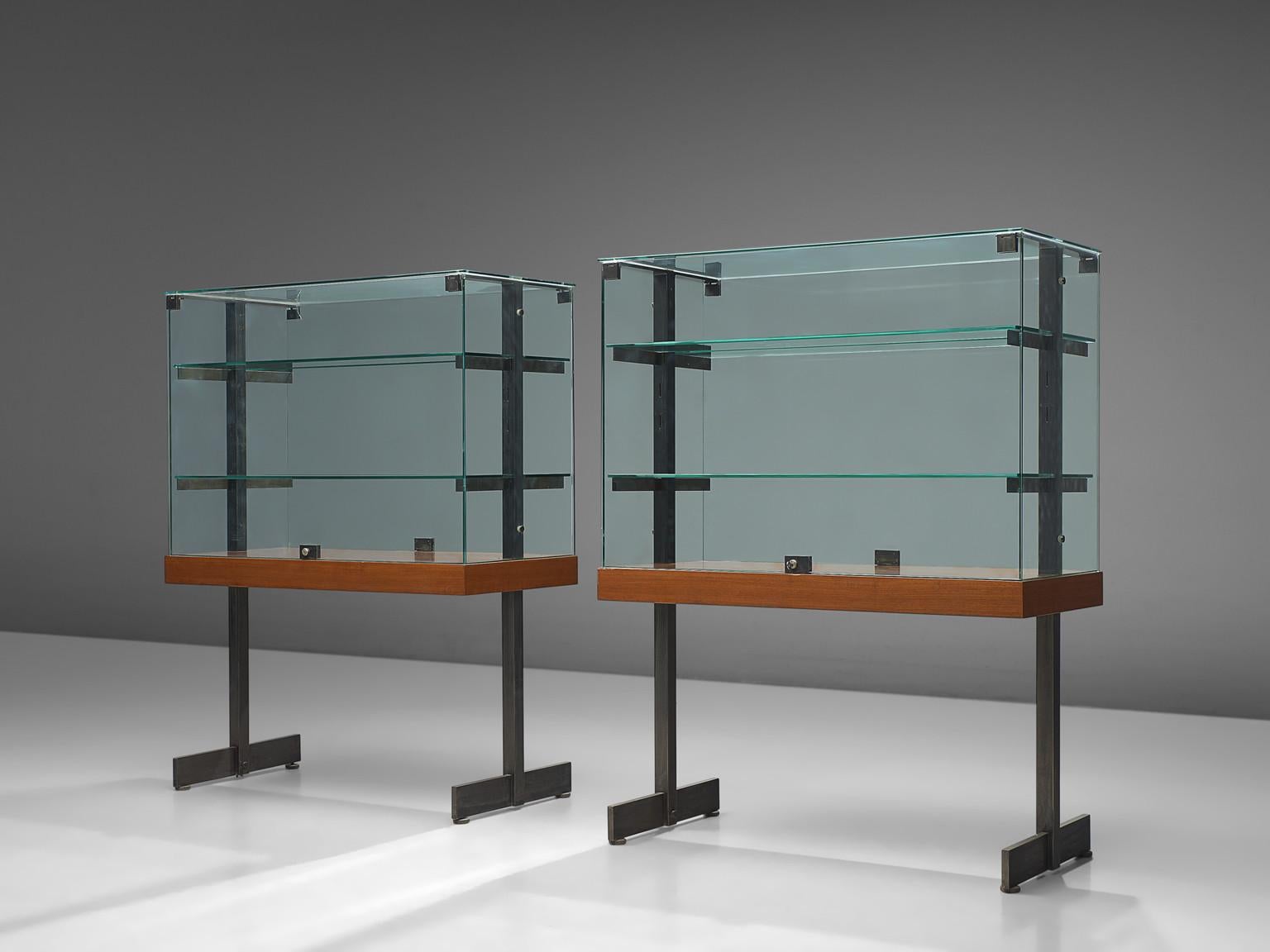 De Coene, showcases, teak, steel, glass, Belgium, 1960s 

Modernist showcases with lockable doors, accompanied with a steel frame and wooden shelf. The vitrines feature the Brutalist characteristics of De Coene. These pieces were originally designed