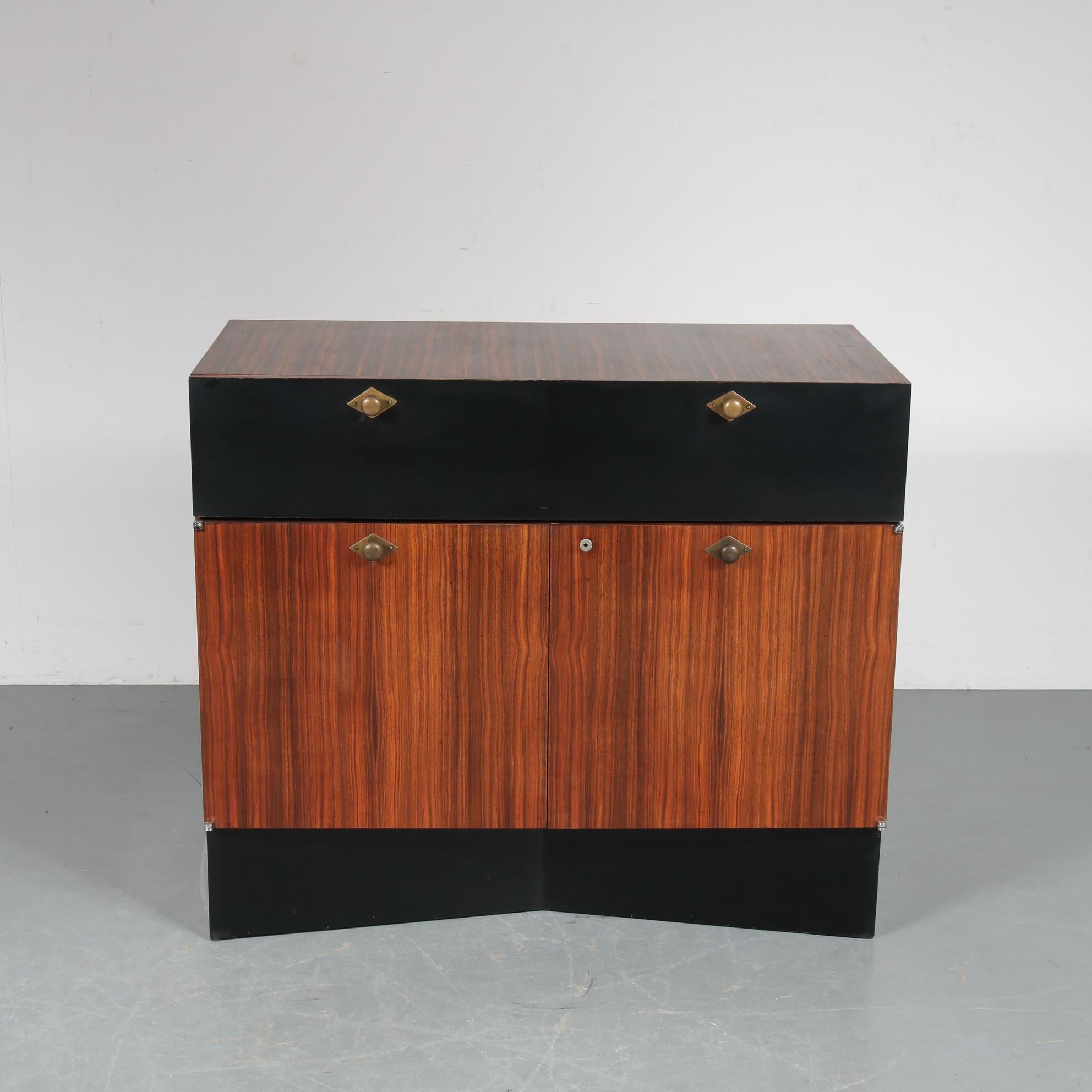 A rare sideboard designed and manufactured by De Coene in Belgium, circa 1960.

This beautiful piece has a wonderful, luxurious appearance, from the top series of De Coene. It is made of high quality zebrano wood with black laminated top doors and