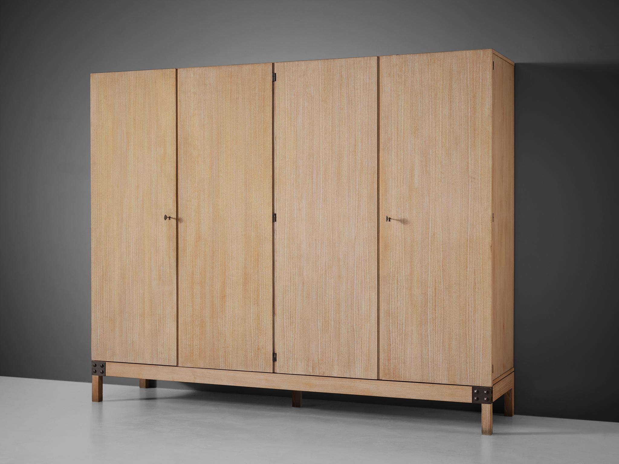 De Coene, wardrobe, model 'Yvette', white stained oak, metal, Belgium, 1970s.

This rare wardrobe is manufactured by De Coene and features a body made of white stained oak with four doors. The interior has a wonderfully practical layout with