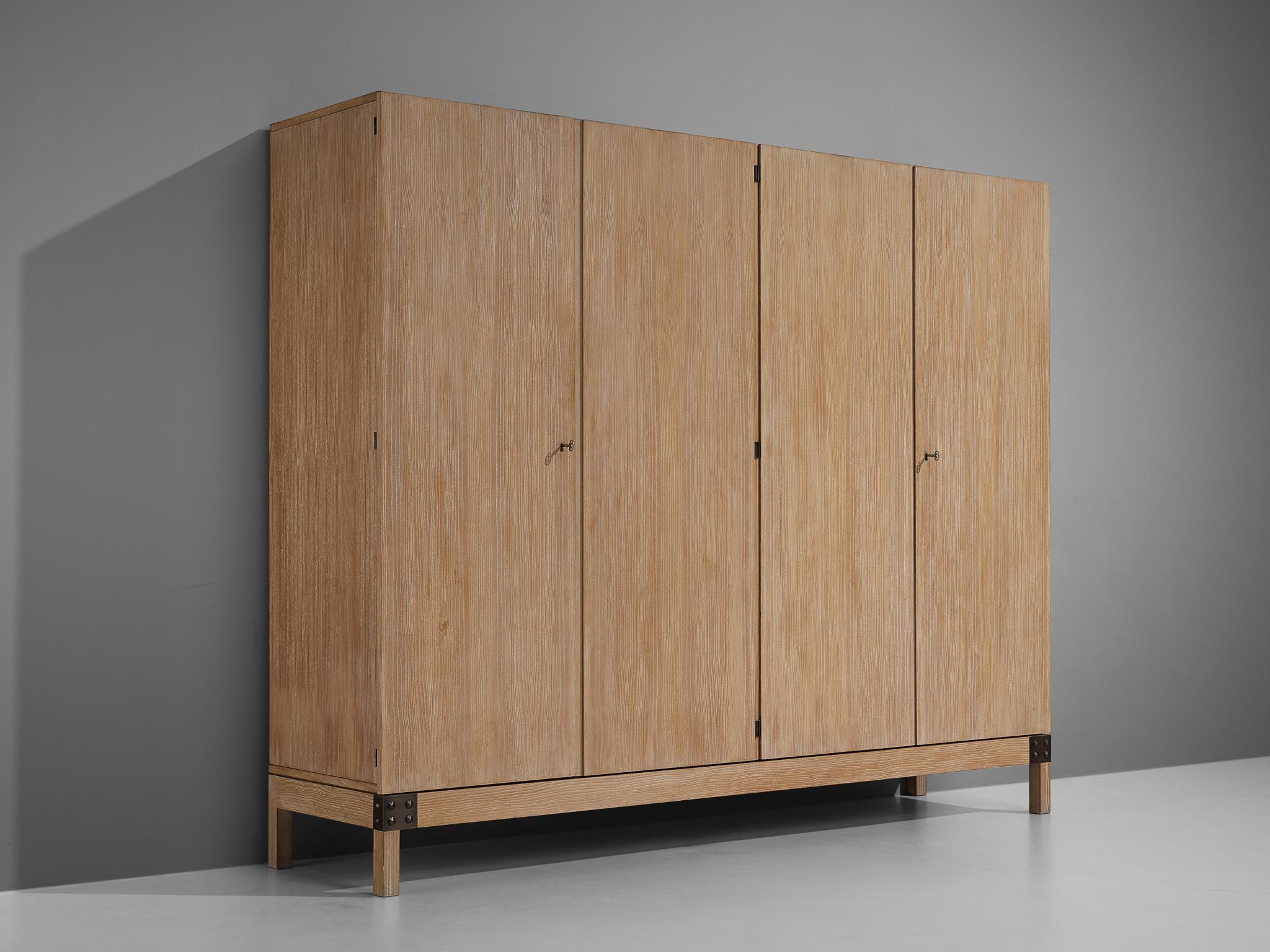 De Coene, wardrobe, model 'Yvette', white stained oak, metal, Belgium, 1970s.

This rare wardrobe is manufactured by De Coene and features a body made of white stained oak with four doors. The interior has a wonderfully practical layout with