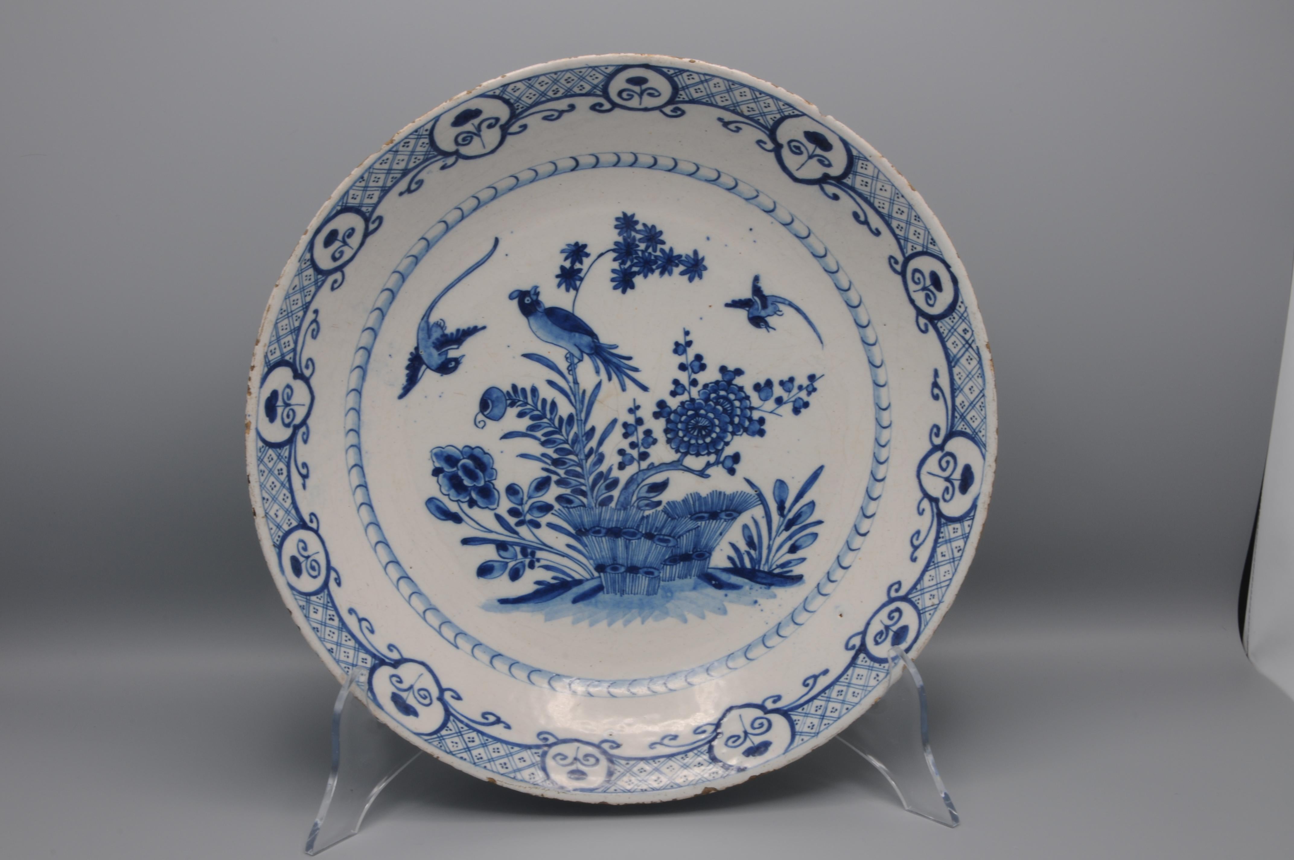 Extraordinary Blue Delftware (deep) platter with chinoiserie decoration of three birds above blossoming peony and flower sprays.
The border and with a decoration of tracery and cartouches. 
marked mark of Jacob van der Kool, De Grieksche A,