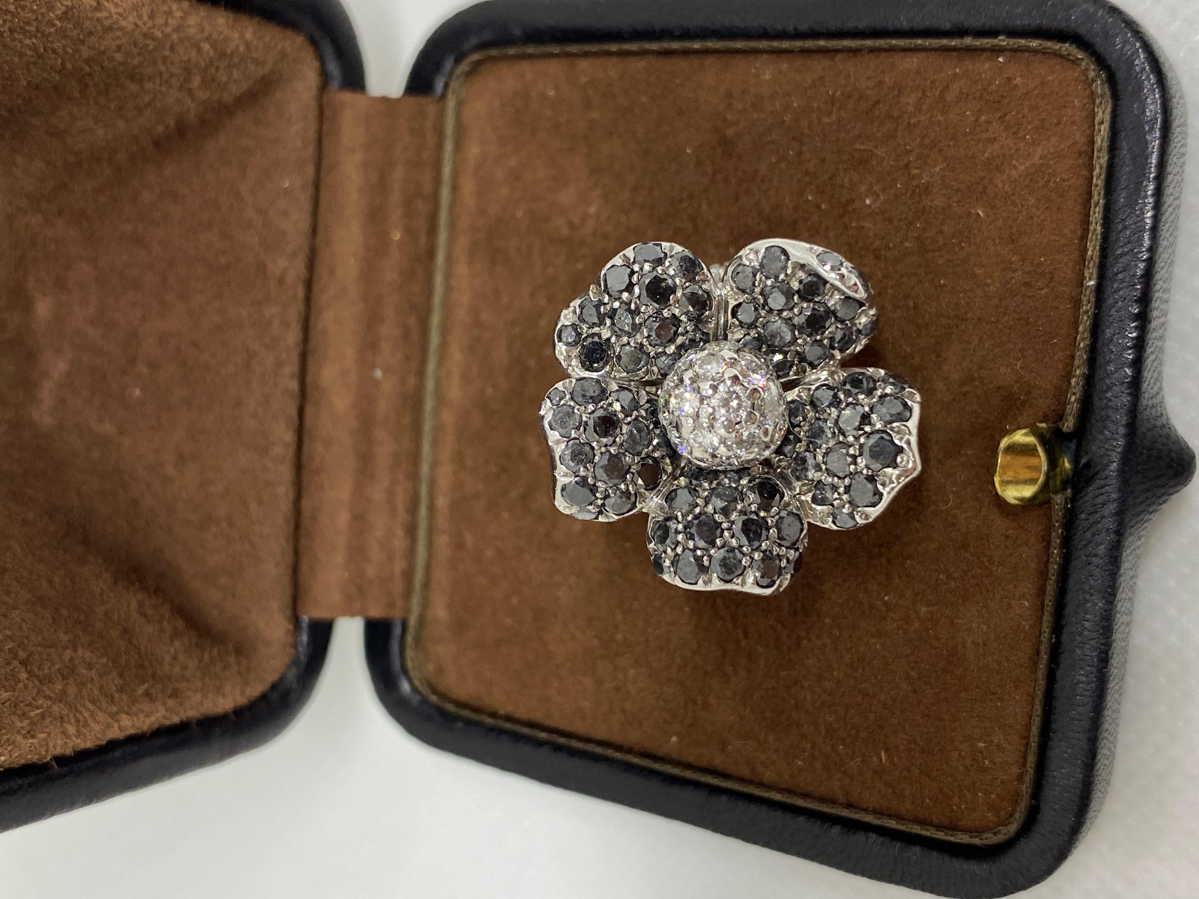 Gorgeous de GRISOGONO ring made in 18K White Gold with Black & White Diamonds. Ring size is US 5.5mm with a diameter of 16.38 mm. The flower on top is 21 x 23 mm. White diamonds: 1.75 cts. Black diamonds: 3.30 cts. All black diamonds are natural