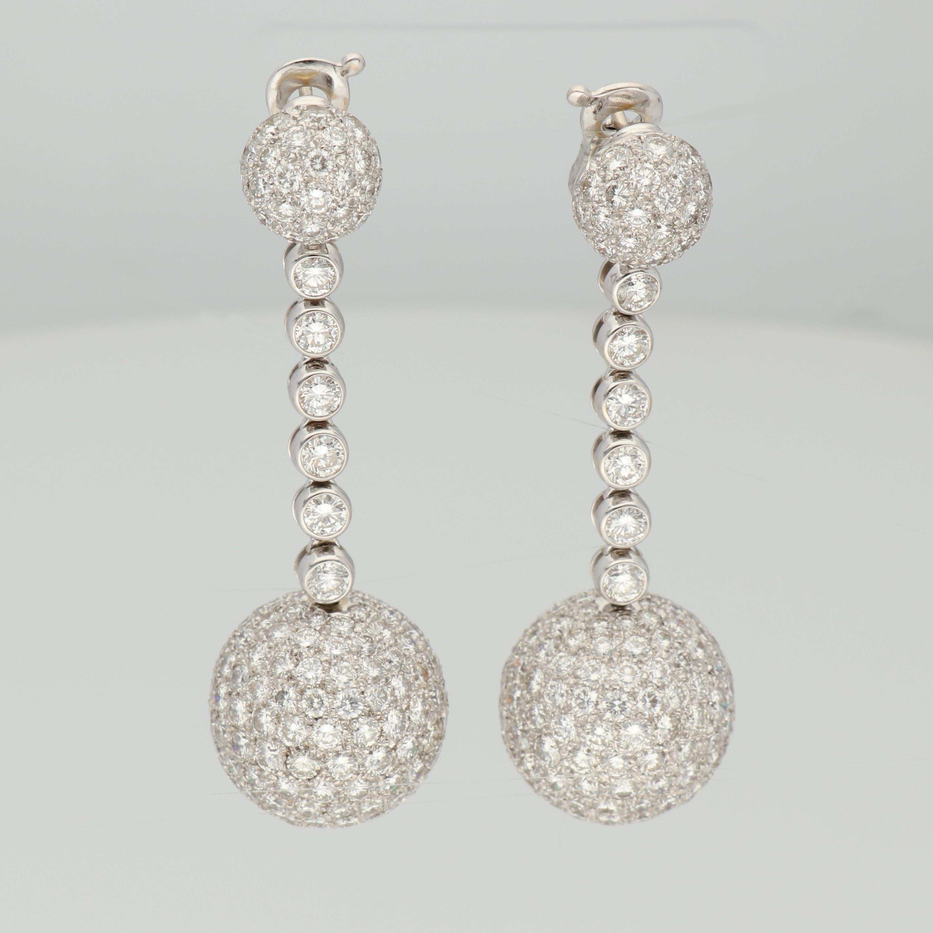 A pair of 18K white gold ball-shaped pendant earrings, set with 27.30 carats of round-cut white diamonds. 

Inspired by the limelight and glamour of jet-set parties, BOULE is the brightest and most iconic expression of de GRISOGONO jewellery