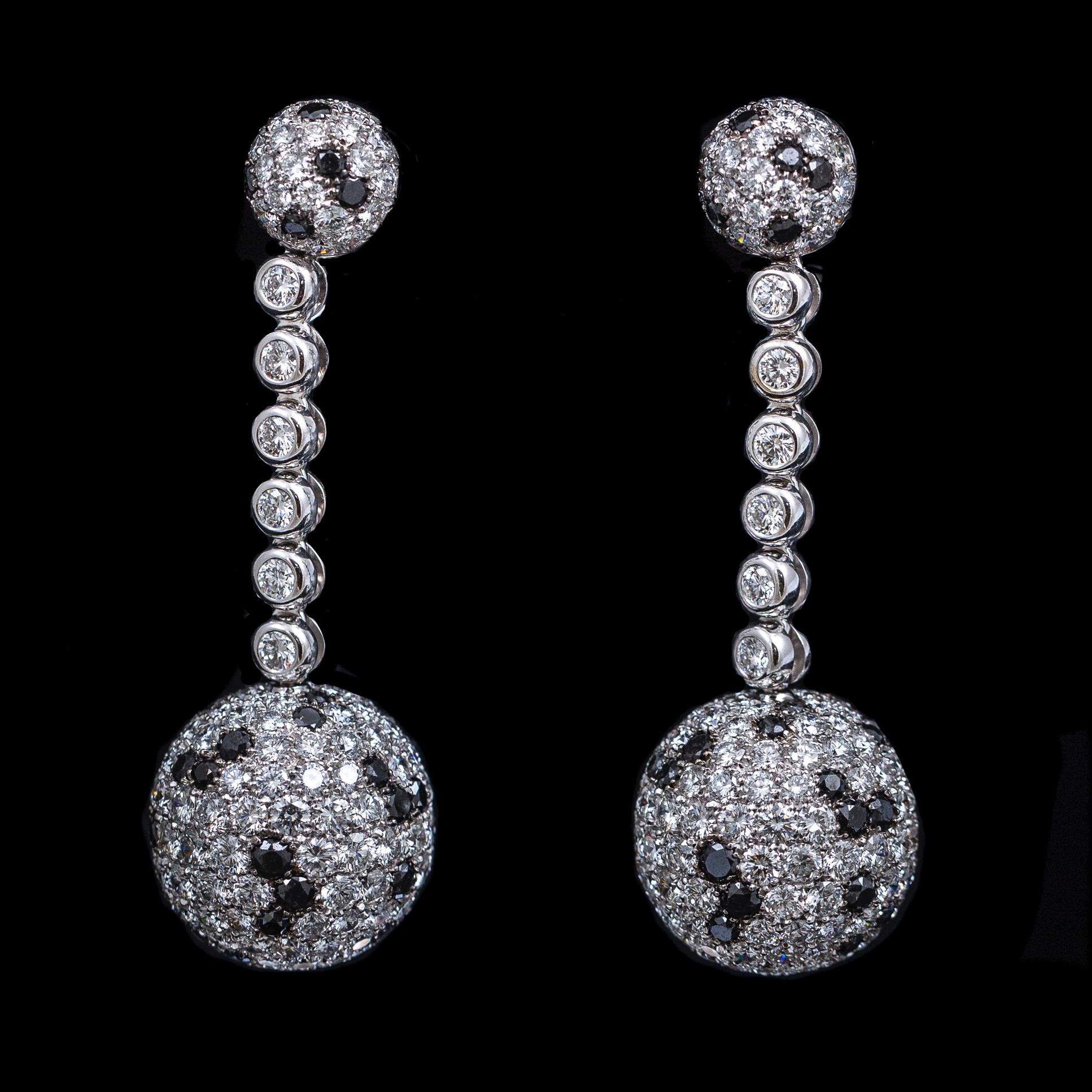 de GRISOGONO Boule round brilliant-cut colorless and black diamond ball dangle drop earrings in 18kt white gold, circa 2000. From the brand’s “Boule” collection and resembling a dalmatian’s black-and-white spotted pattern, each earring is designed