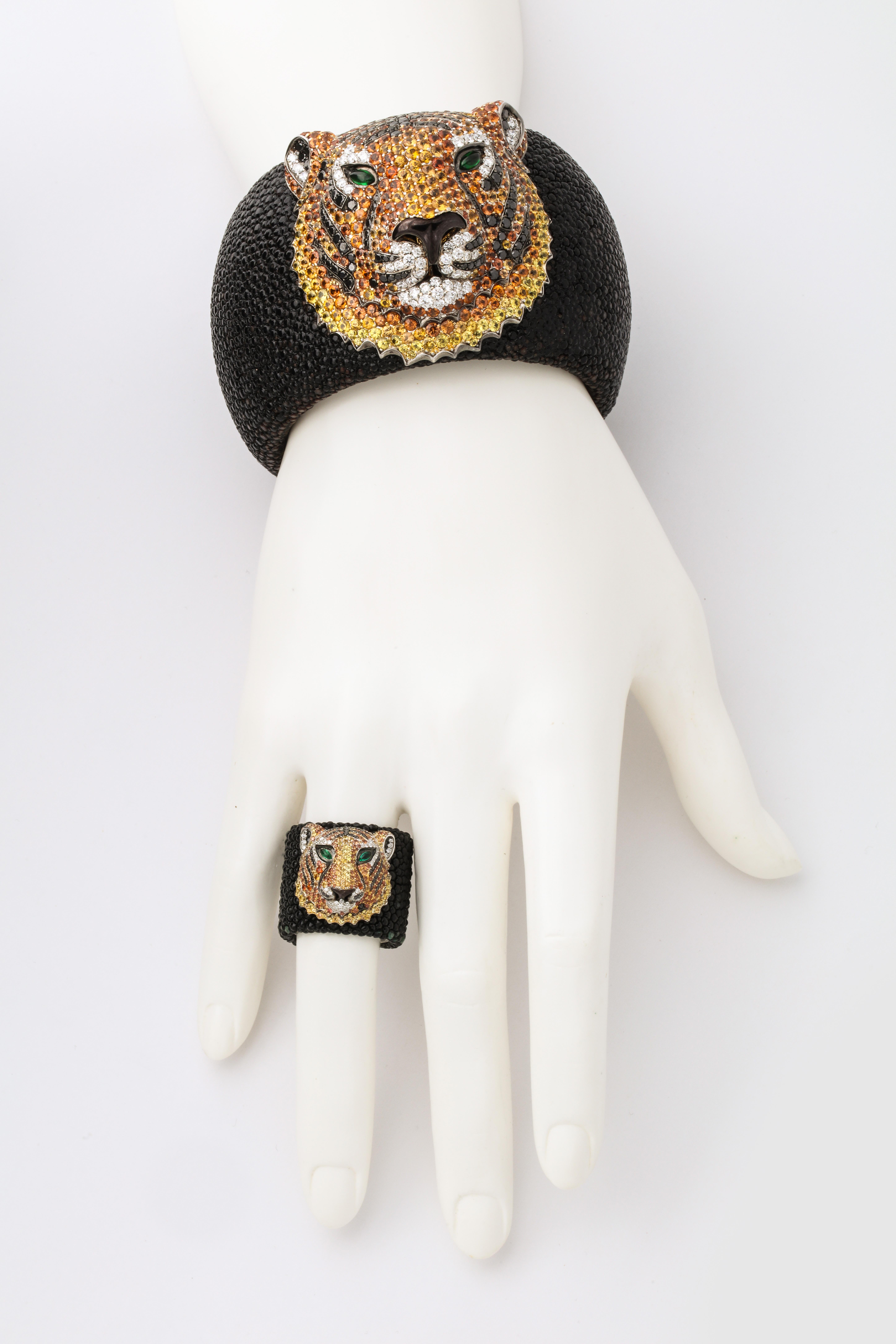 Black shagreen cuff and ring each topped with a sapphire, black and white diamond and emerald tiger.  Bold design executed with incredible detail- the stone setting alone is a work of art.  Finished with 18kt white gold details, signed, numbered and