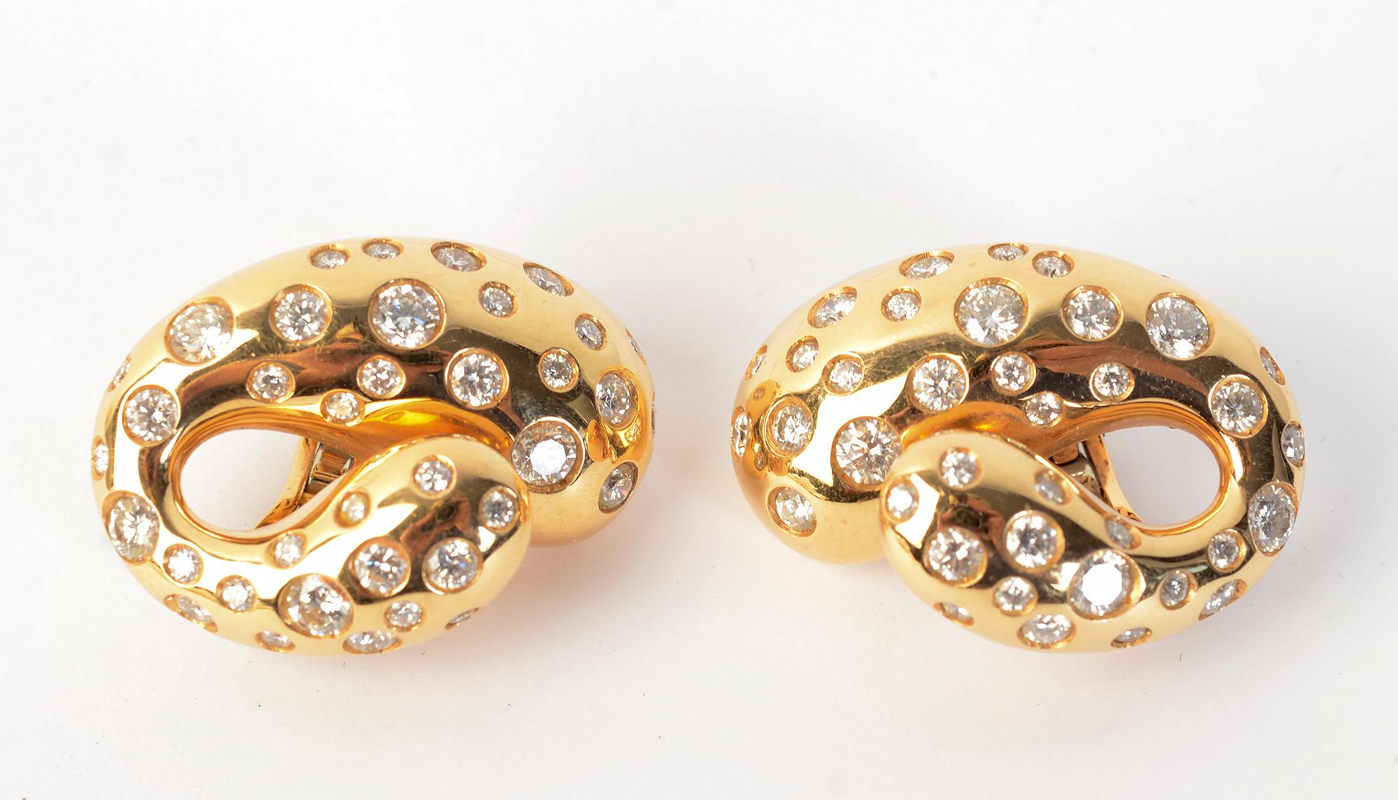 Powerful and elegant gold and diamond earrings by de Grisogono. The crescent shaped earrings have 75 round brilliant cut  diamonds in a variety of sizes. The total weight is approximately 1.5 carats. 
Backs are clips with collapsible posts.
