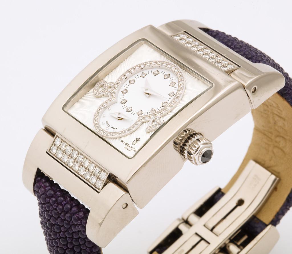 De Grisogono Instrumentino
Model: TINO S02 AT
Case: Polished white gold set with white diamonds; front & back case anti-reflection sapphire glass 
Dial:  White guilloché enamel, set with diamonds
Bracelet: Purple galuchat strap with polished white