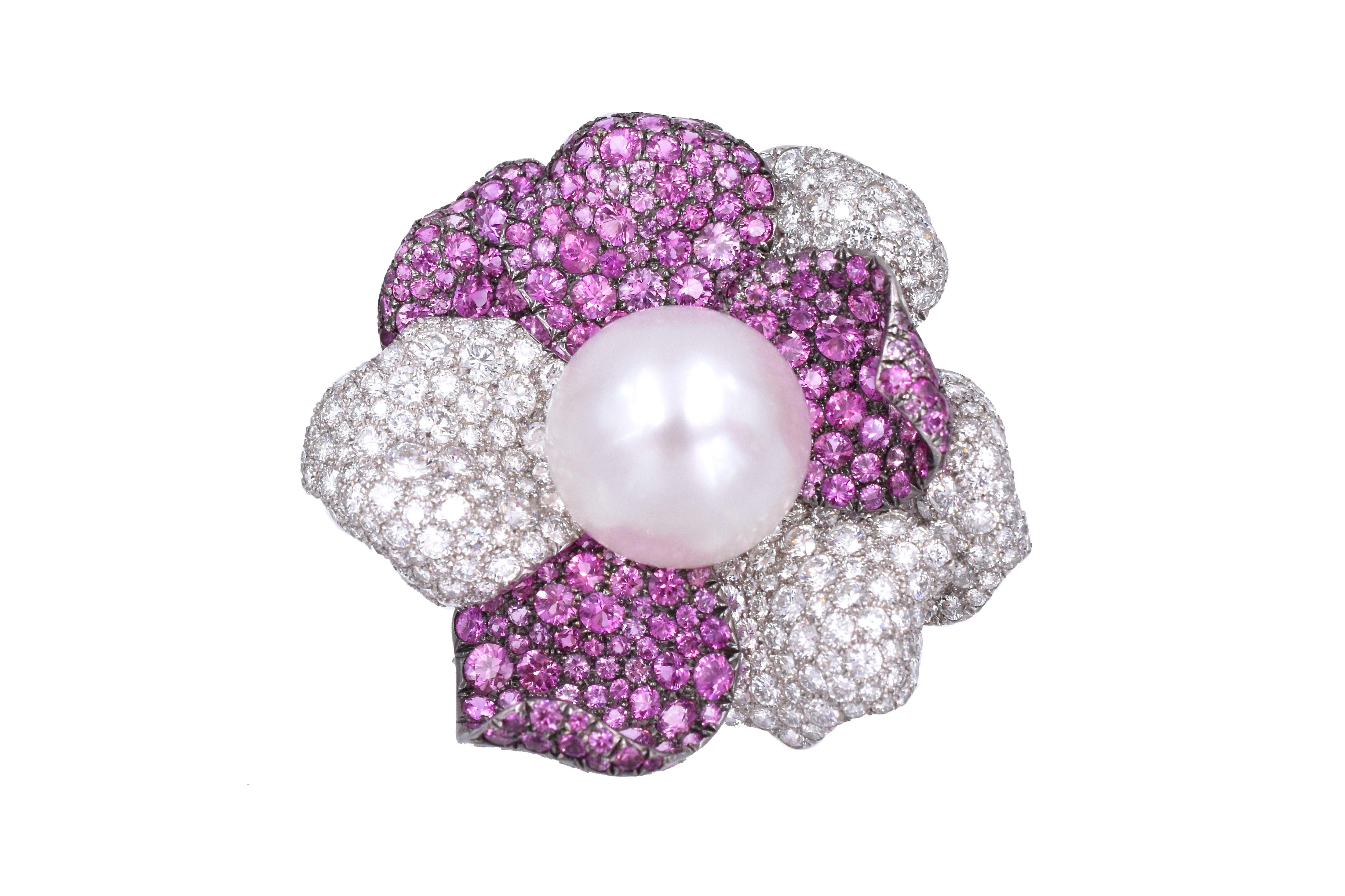 Beautiful blossoming floral design brooch, 
Impressive  19.1mm pearl surrounded with   petals  incrusted with  diamond & pink sapphire.
Estimated weight of diamonds is 11.53cts
Estimated weight of pink sapphires is 15.72cts
Set in 18k white