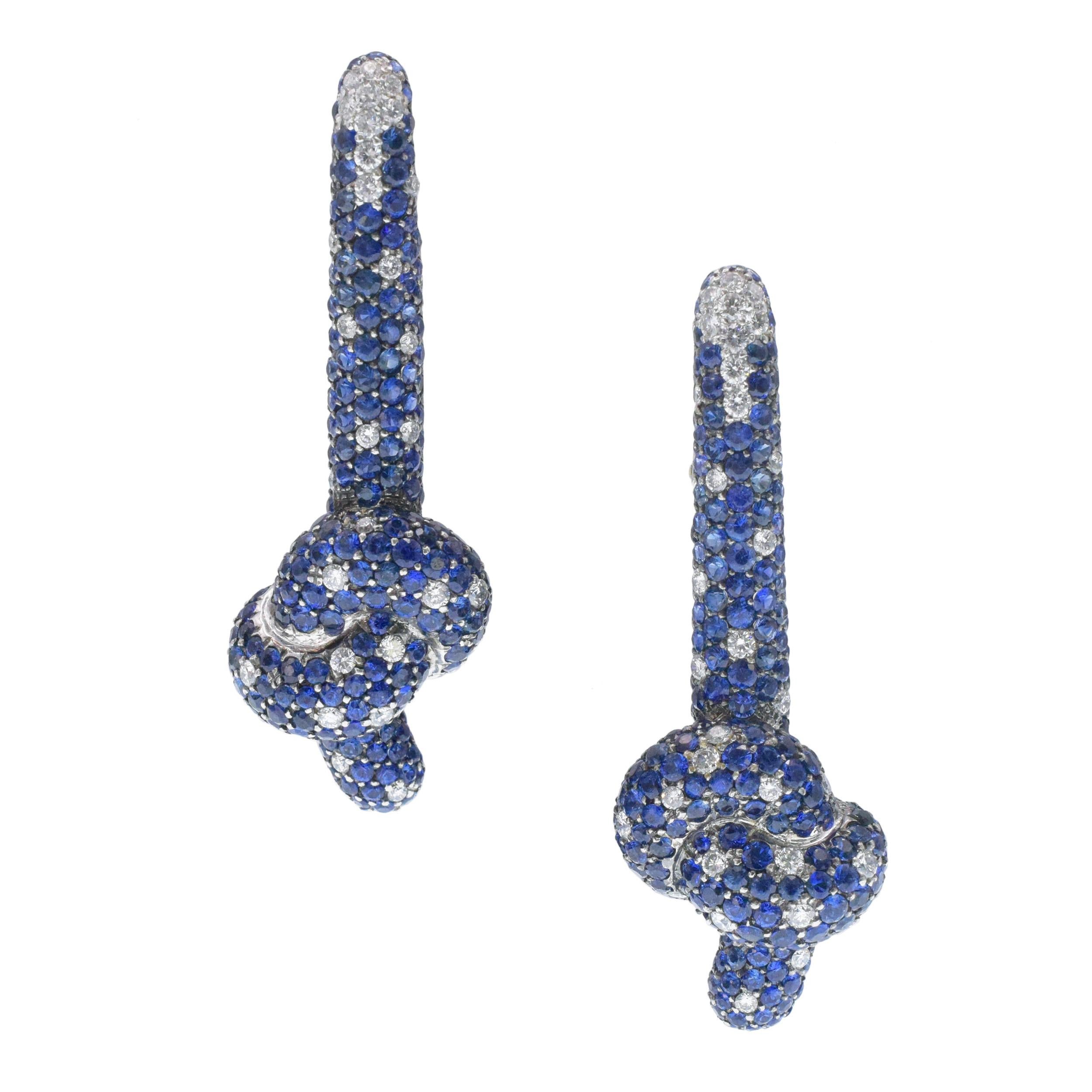 De Grisogono Sapphire And Diamond Knot Drop
Earrings in 18k White gold. The earrings are
set with 69 round brilliant cut diamonds with total weight of approximately 2.00ct, color F-G, clarity VS,
and approximately 20.00ct of round sapphires.