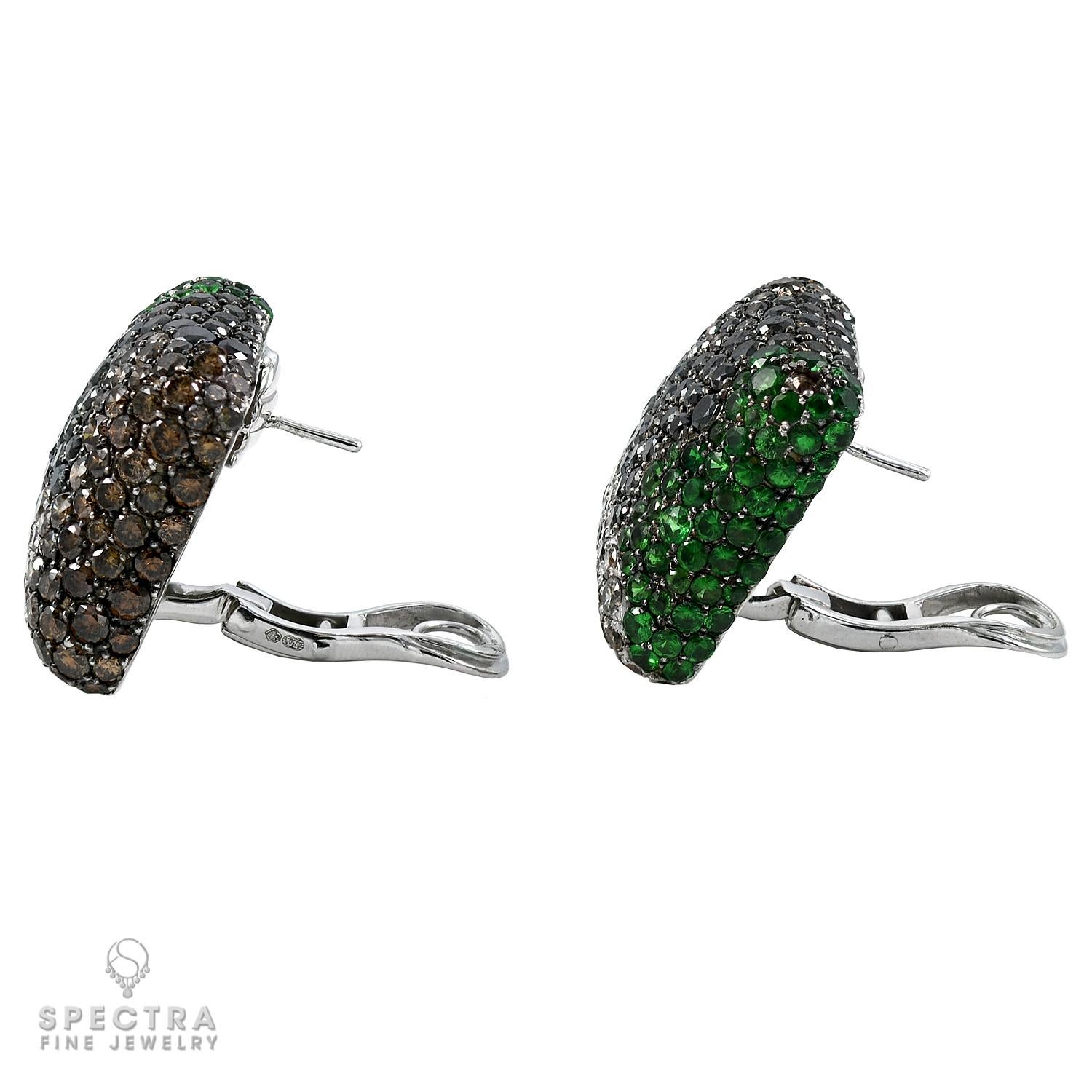 Presenting an exquisite pair of earrings crafted in 18k white gold, adorned with a mesmerizing array of multicolored round diamonds, totaling around 10.68 carats. 

Additionally, the earrings feature Tsavorites, with a combined weight of