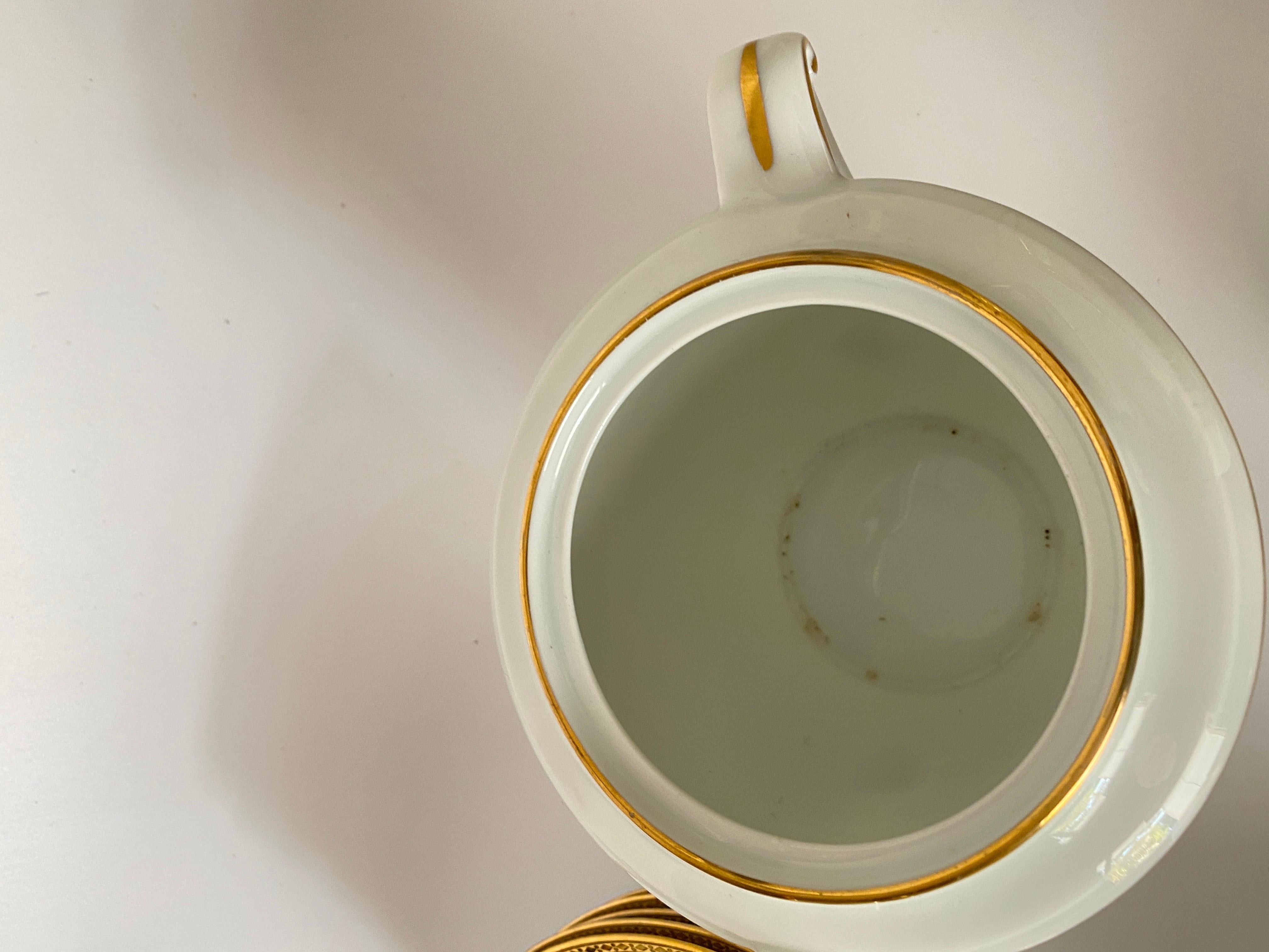 This service is in Limoges Porcelain. We have the mark underneath, ch.Field Havilland - Limoges.
It has been made in France circa 1930. 
11 coffee cup plate
6 cups
1 sugar pot
1 teapot or coffee pot
In total 19 pieces.
The pieces are covered with 24