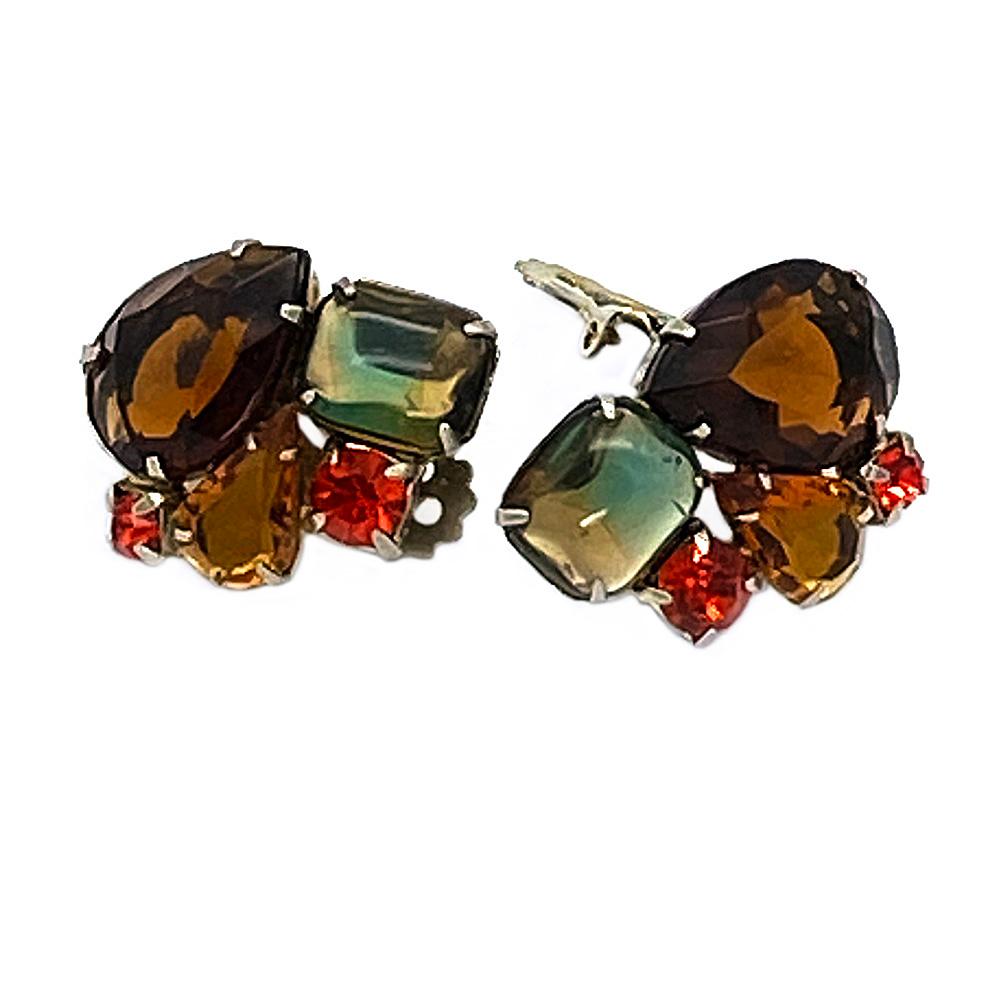 This is a pair of DeLizza & Elster Juliana holiday clip-on earrings. There are topaz, amber, orange red and green/yellow multi-shapes of stones prong set on gold tone metal with open back. The beautiful color combination definitely goes with the