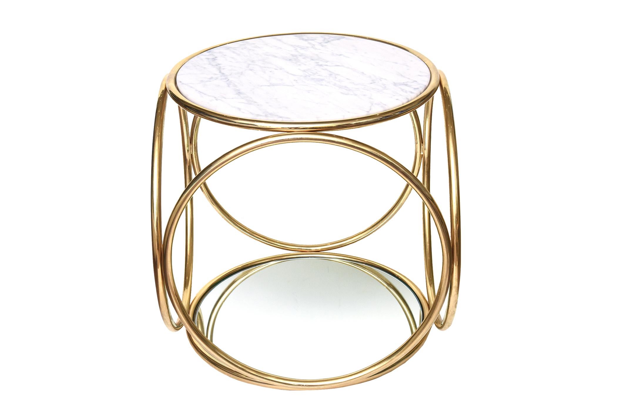 Six rings of gold plated steel make up this very sculptural side table that is versatile. It is from the De La Espada collection from Portugal that was designed by Autoban. It is no longer in production and has not been for awhile. It is from the