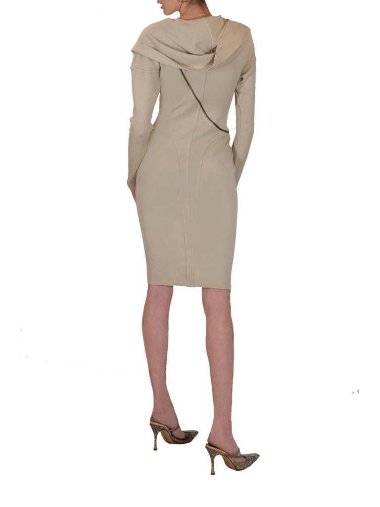Alaia beige wool knitted zipper dress from the seminal 1986 collection. This Museum worthy dress has a body conscious fit and a brass zip that wraps around the body, featuring a draped collar that can also be worn as a hood.

Size L. Model is size 8