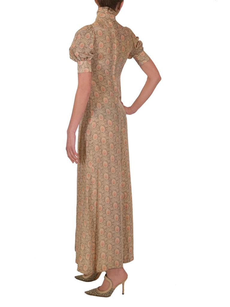 A late 1970’s Biba crepe de Chine flared panel maxi-dress, featuring an all-over organic oval print, each in a stylised foliage frame, on a complementing background, in shades of chamoisée-brown, vanilla-cream and terracotta, with short lantern