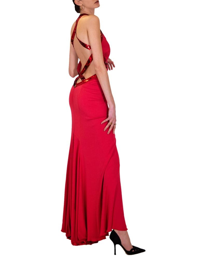 Roberto Cavalli Red Silk Jersey seductive evening gown that plunges to the back and is cutaway at the sides edged in red sequin strips that form straps and cross over in the back.

Roberto Cavalli label. 
Early 2000s

Vintage designer vening dresses