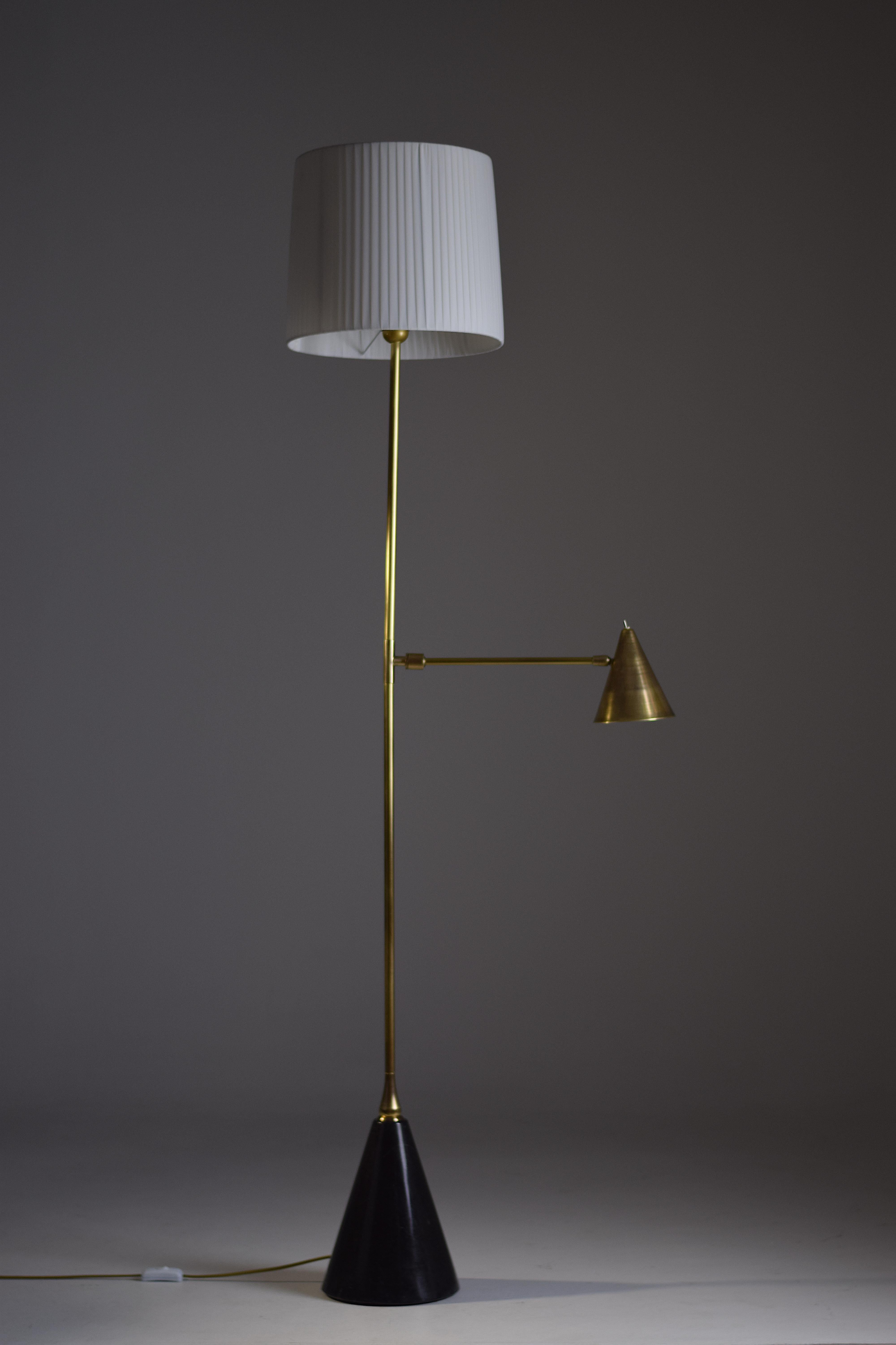 Ce lampadaire contemporain sur mesure est conçu avec une liseuse positionnée à mi-longueur qui articule un abat-jour conique en laiton afin que vous puissiez diriger la lumière avec facilité. Les deux systèmes d'éclairage fonctionnent
