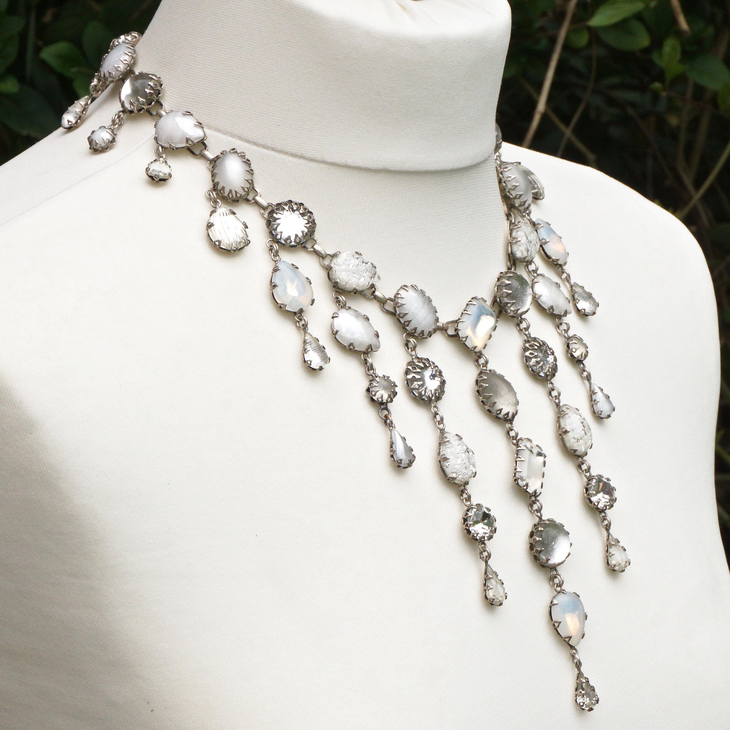 Fabulous De Luxe NYC/A'dam silver tone and art glass drop necklace with a curb link extension chain. Dropping from the necklace are beautiful white, clear and opaline glass drops. The necklace measures length 53.34cm / 21 inches, and the longest