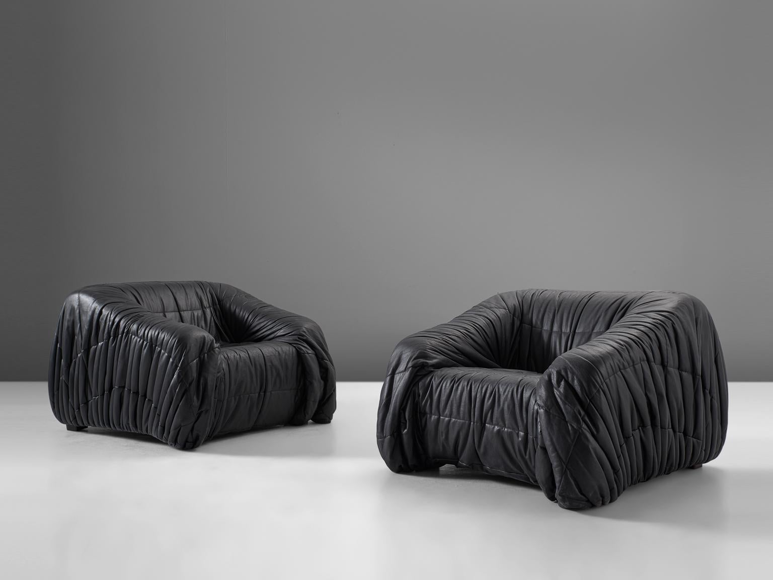 'Piumino' lounge chairs by Jonathan de Pas, Donato D'urbino & Paolo Lomazzi for Dell'Oca, Italy, 1970. 

These lounge chairs are completely moulded out of foam and covered with folded black, thick butter-soft leather. One of the mean traits of