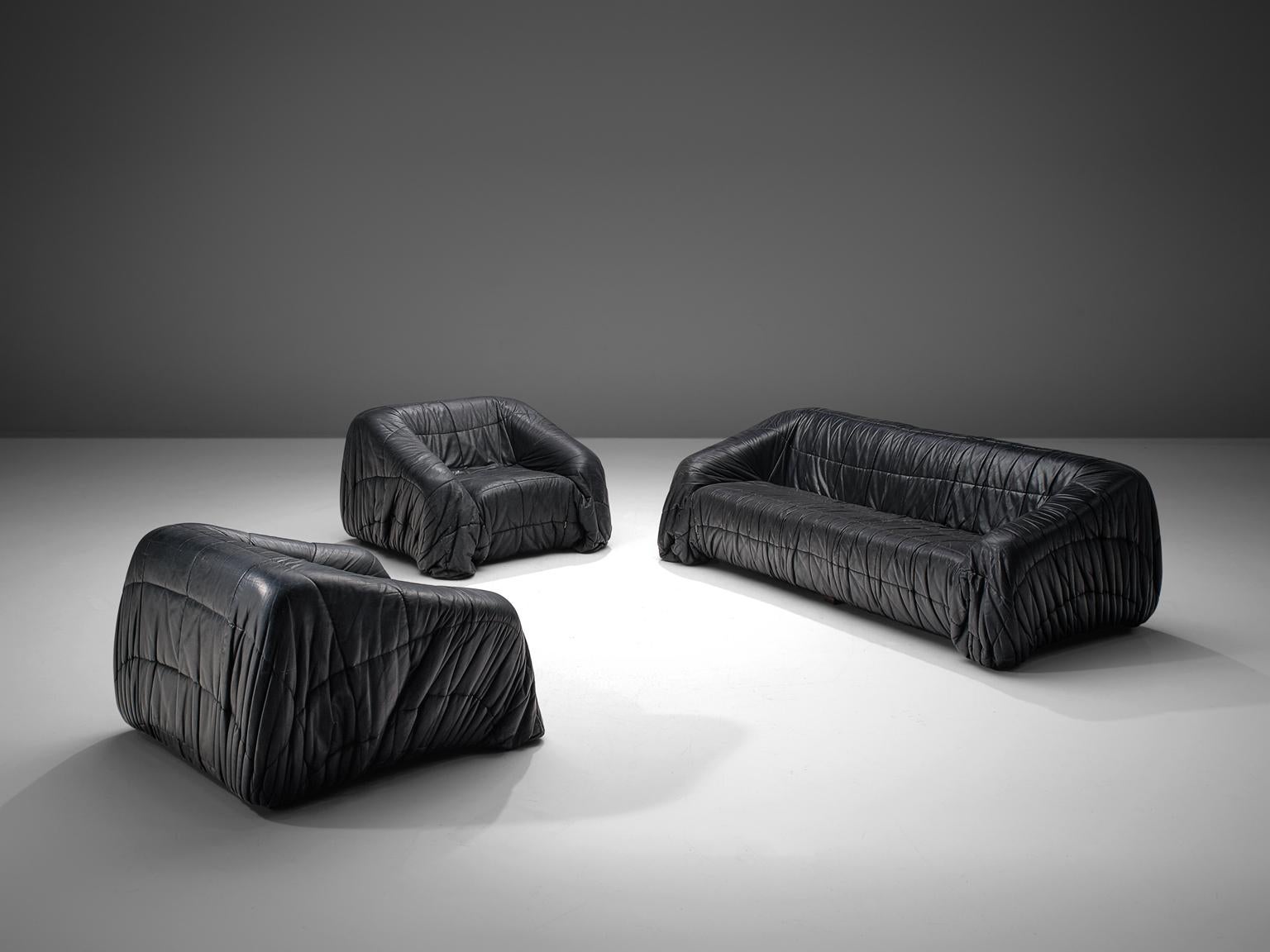 Jonathan de Pas, Donato D'urbino & Paolo Lomazzi for Dell'Oca 'Piumino' lounge living room set, black leatherette, Italy, 1970. 

These lounge chairs and sofa are completely moulded out of foam and covered with folded black, thick butter-soft