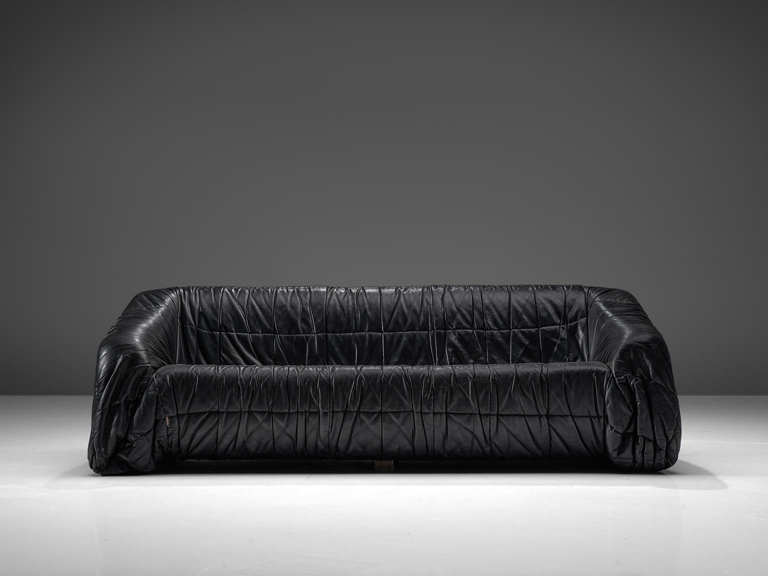 Gionathan de Pas, Donato D'urbino & Paolo Lomazzi for Dell'Oca 'Piumino' sofa, black leatherette, Italy, 1970. 

This sofa is completely molded out of foam and covered with folded black, thick butter-soft leatherette. One of the mean traits of this