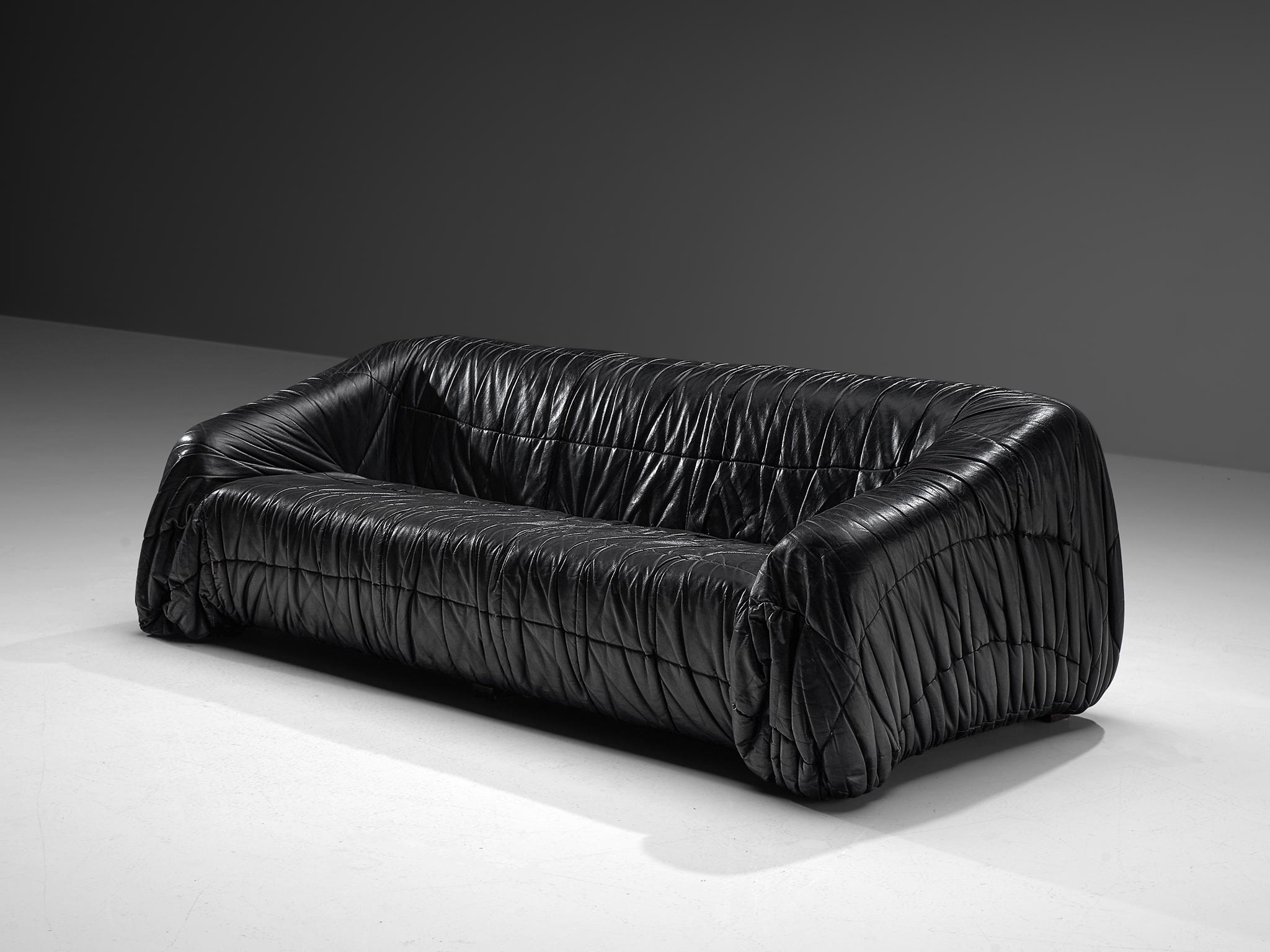 Gionathan de Pas, Donato D'urbino & Paolo Lomazzi for Dell'Oca 'Piumino' sofa, black leatherette, Italy, 1970. 

This sofa is completely molded out of foam and covered with folded black, thick butter-soft leatherette. One of the mean traits of