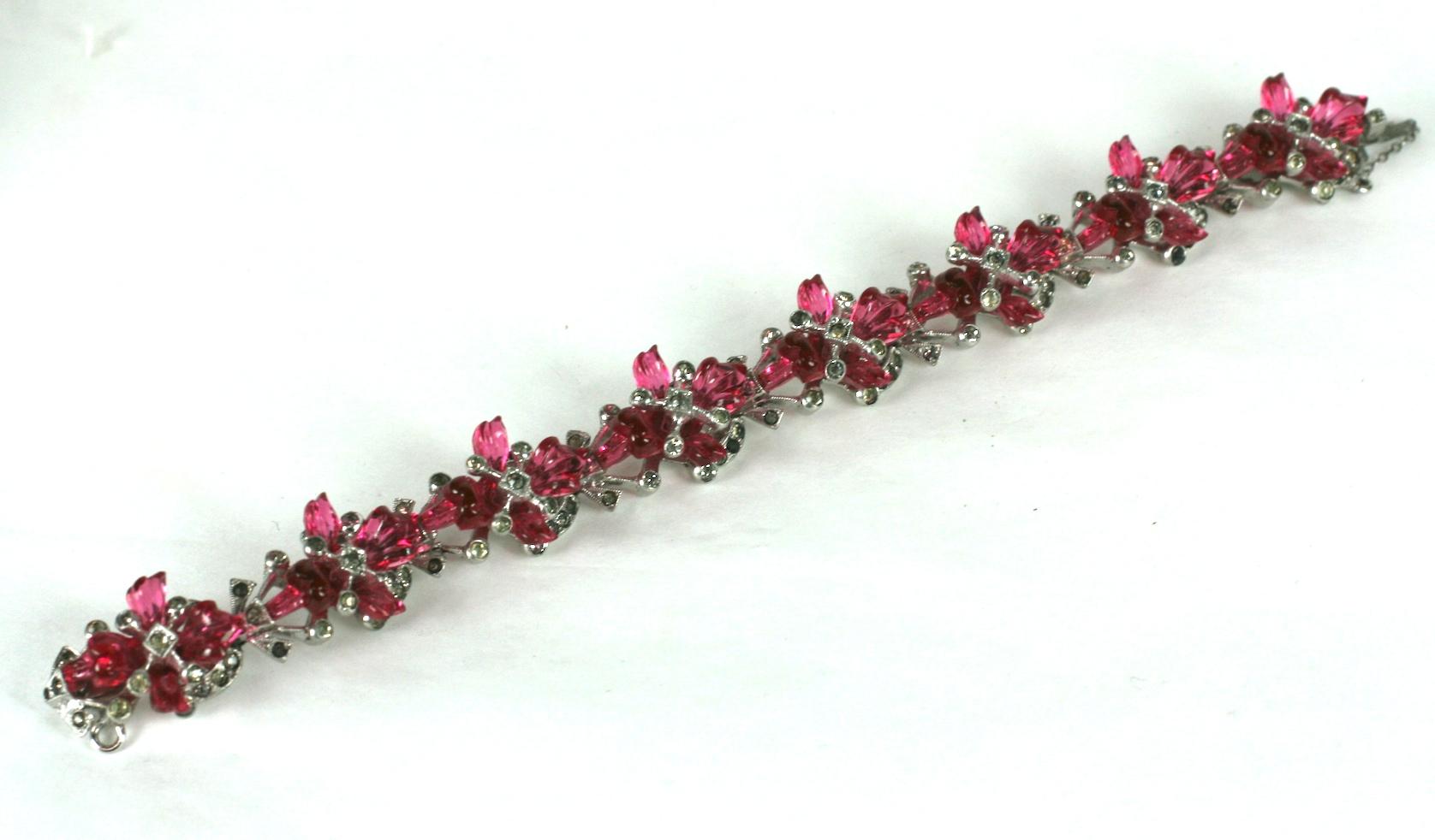 Ralph de Rosa rare Art Deco floral fruit salad  bracelet of crystal rhinestone pave articulated links set with faux ruby three dimensional glass orchid flower heads on rhodium plate base metal. The orchid flowers are of pressed and fine wheel carved