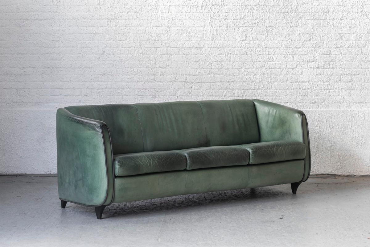 Sculptural 3-seater sofa with beautiful curves, produced by De Sede in Switzerland in the 1970’s. This rare piece is finished in high quality green leather. Carries De Sede’s signature fabric at the bottom of the seats. Patinated but in good