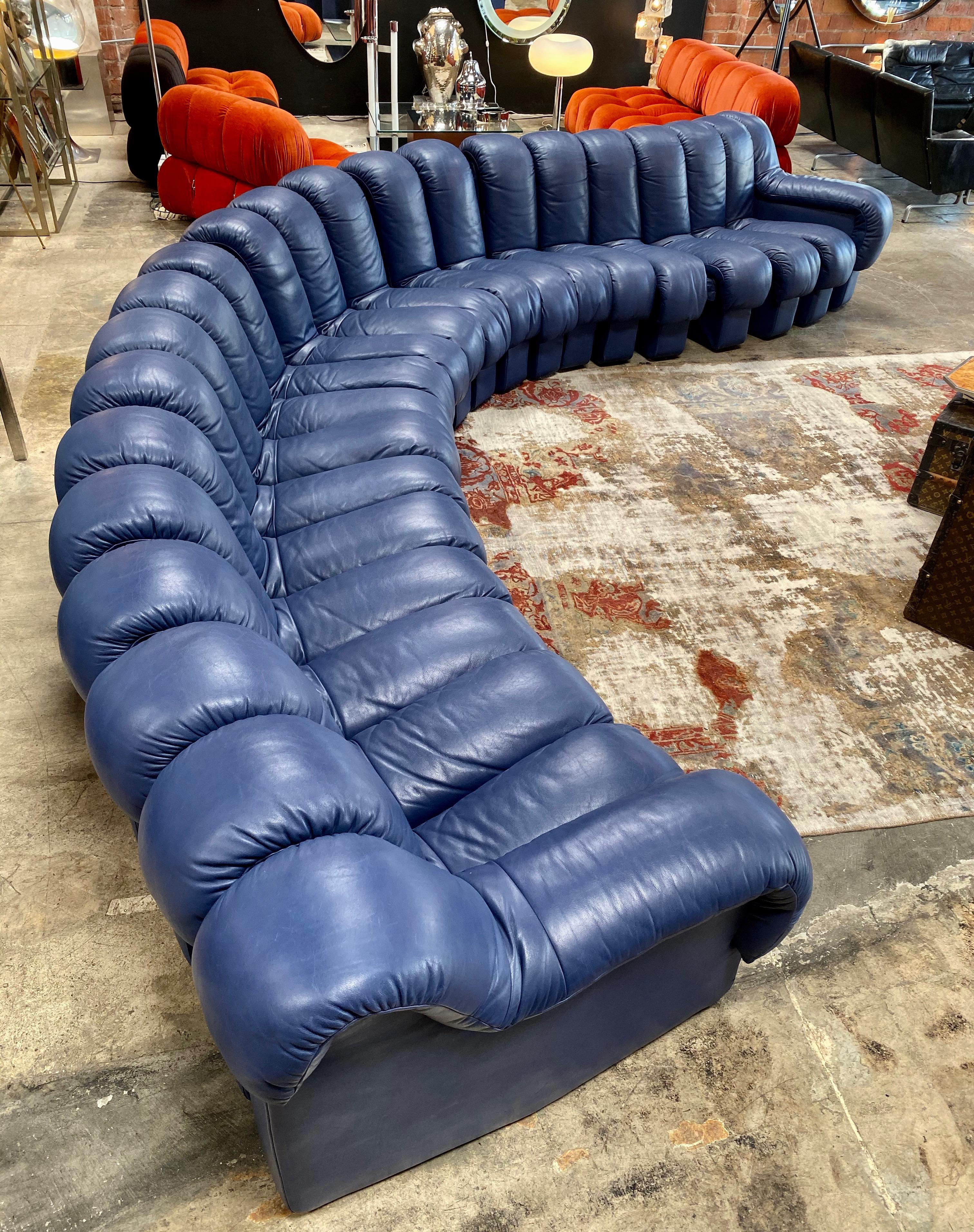One of the most striking pieces of 1970s design: the De Sede DS600 modular sofa.
This particular example features rich and supple blue leather comprised of 22 elements, with felt-lined sides. As you can see in the photos, the sofa can be twisted