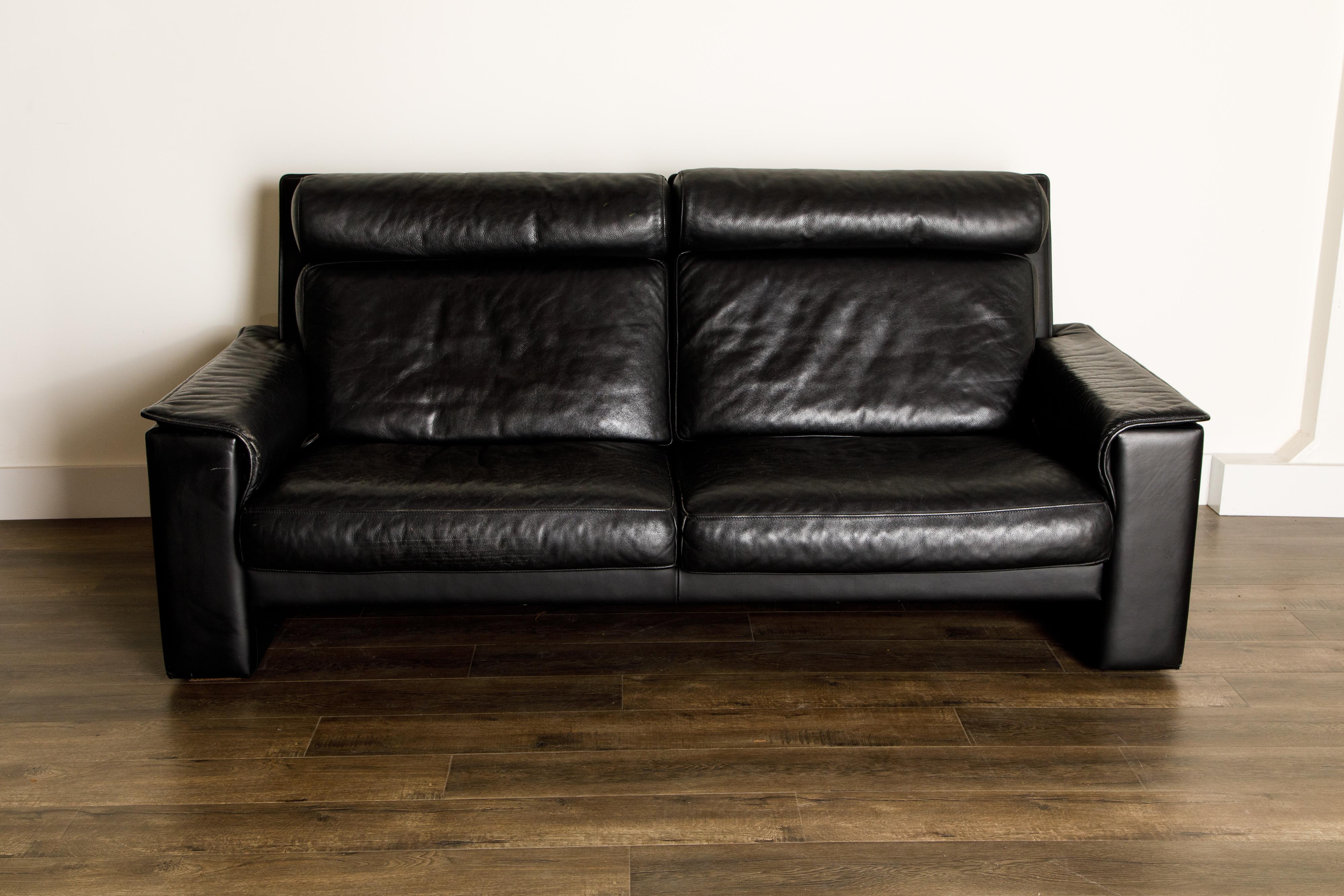 This incredible reclining sofa by De Sede, signed with original De Sede emblem on the lower side, the leading Swiss design company since the 1960s, is skillfully crafted in Switzerland from thick, heavy, quality black leather. While this is