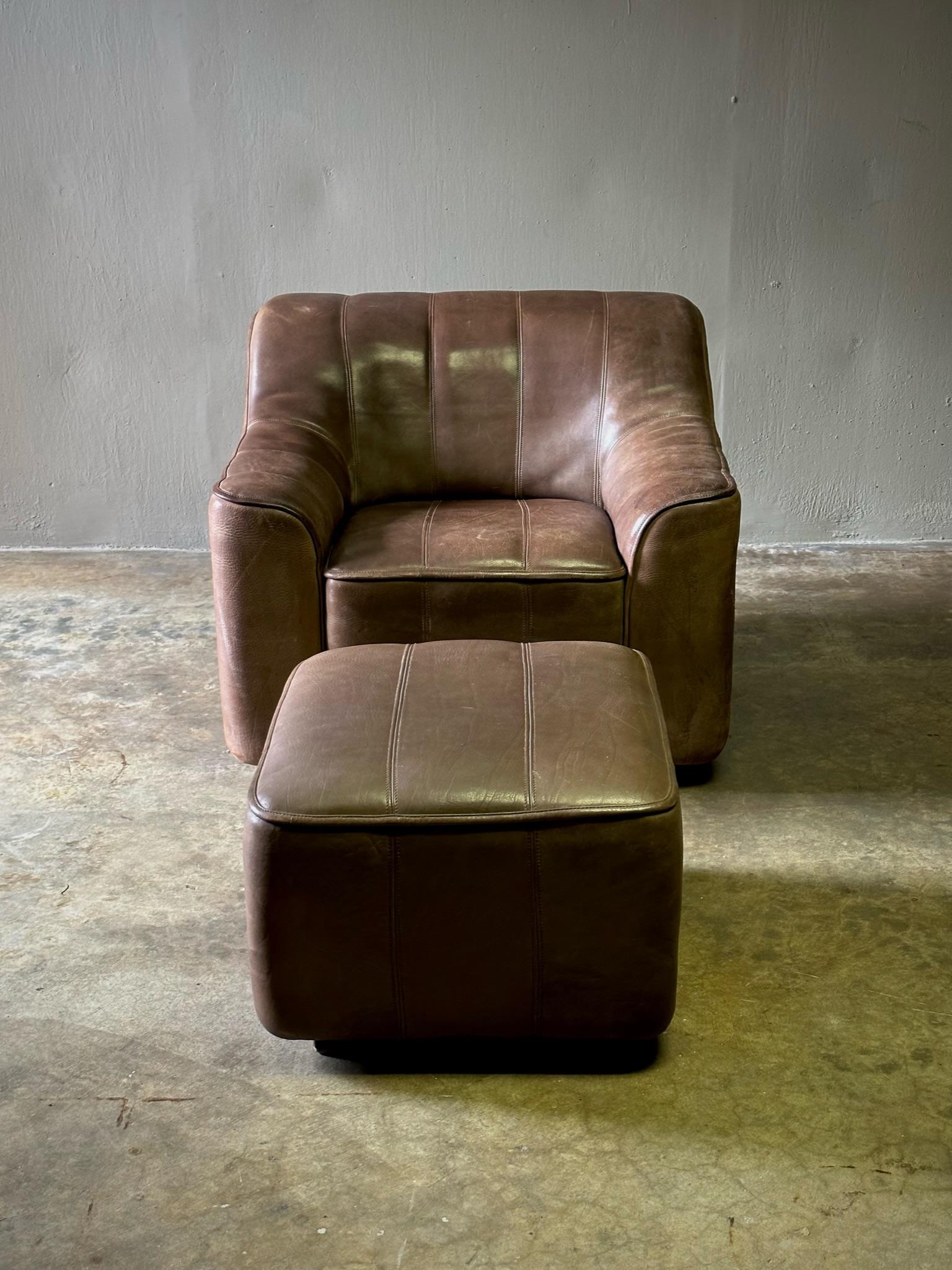 Dark chocolate brown leather armchair and ottoman by De Sede. Sumptuous yet understated with handsome, timeless appeal. The patina on the leather is exquisite.

Switzerland, circa 1970

Dimensions: Chair 34W x 34D x 28H ;Ottoman 21W x 23D x 15H
