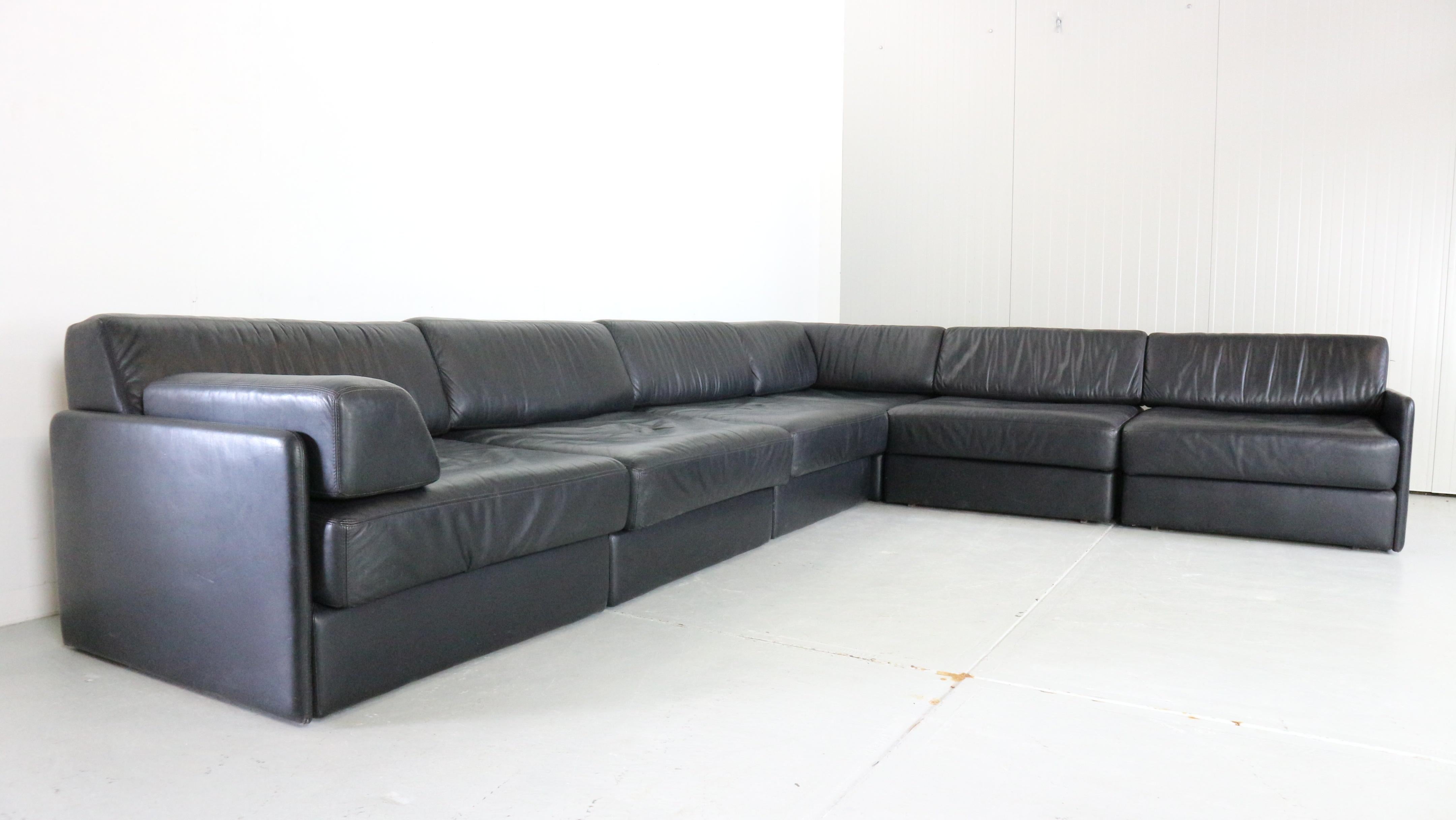 Mid- Century modern period sectional large sofa from the 1970s, 
This sofa is made of six sectional elements.
Black high quality leather still in great condition. 
Moreover, this piece of furniture is designed to provide an ultimate level of comfort