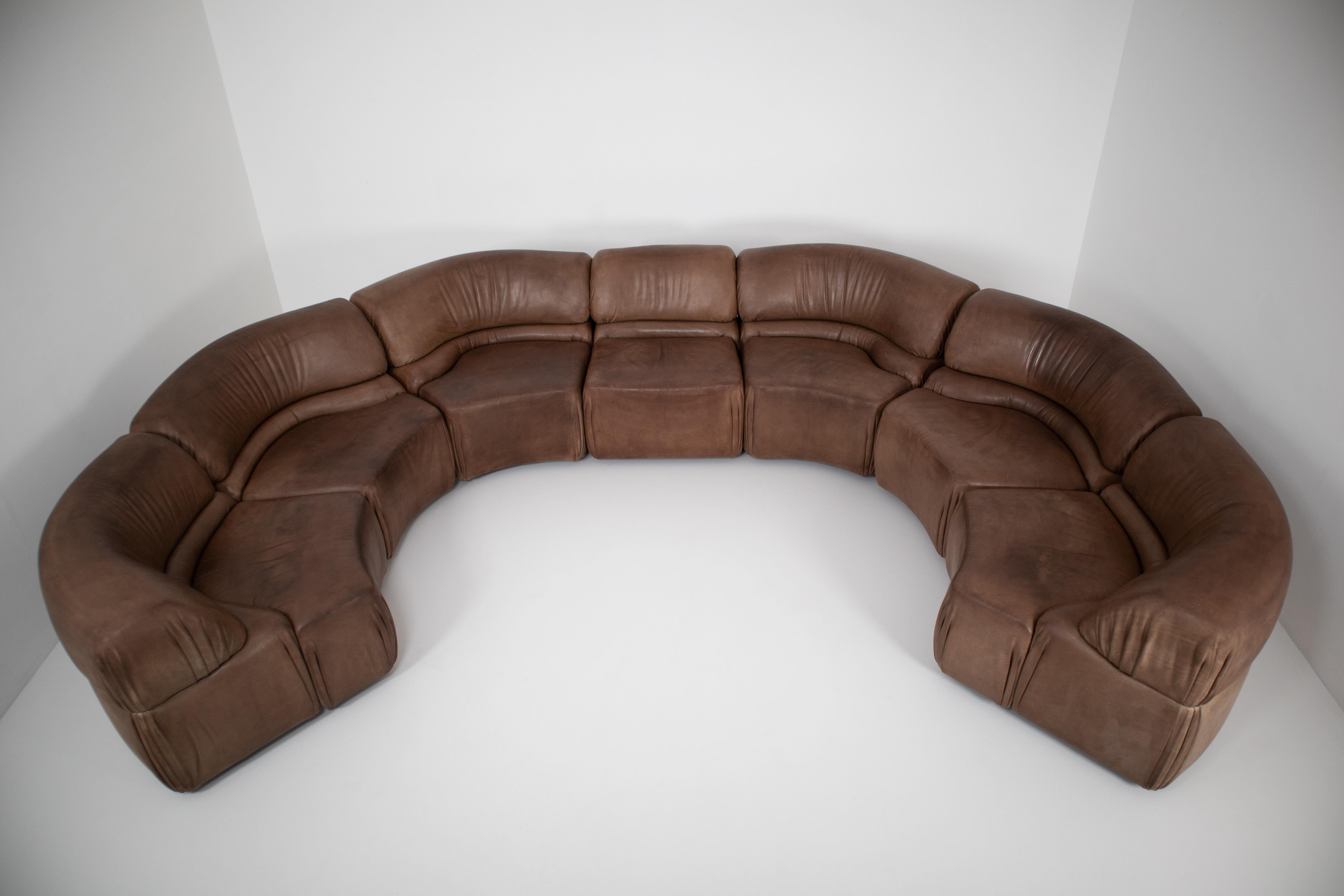 Comfortable so called 'Cosmos' elemented sofa designed and manufactured by De Sede, Switzerland, 1970. This sofa has a wooden structure stuffed with foam and covered with buffalo leather. The sofa is in patinated brown leather and is in good