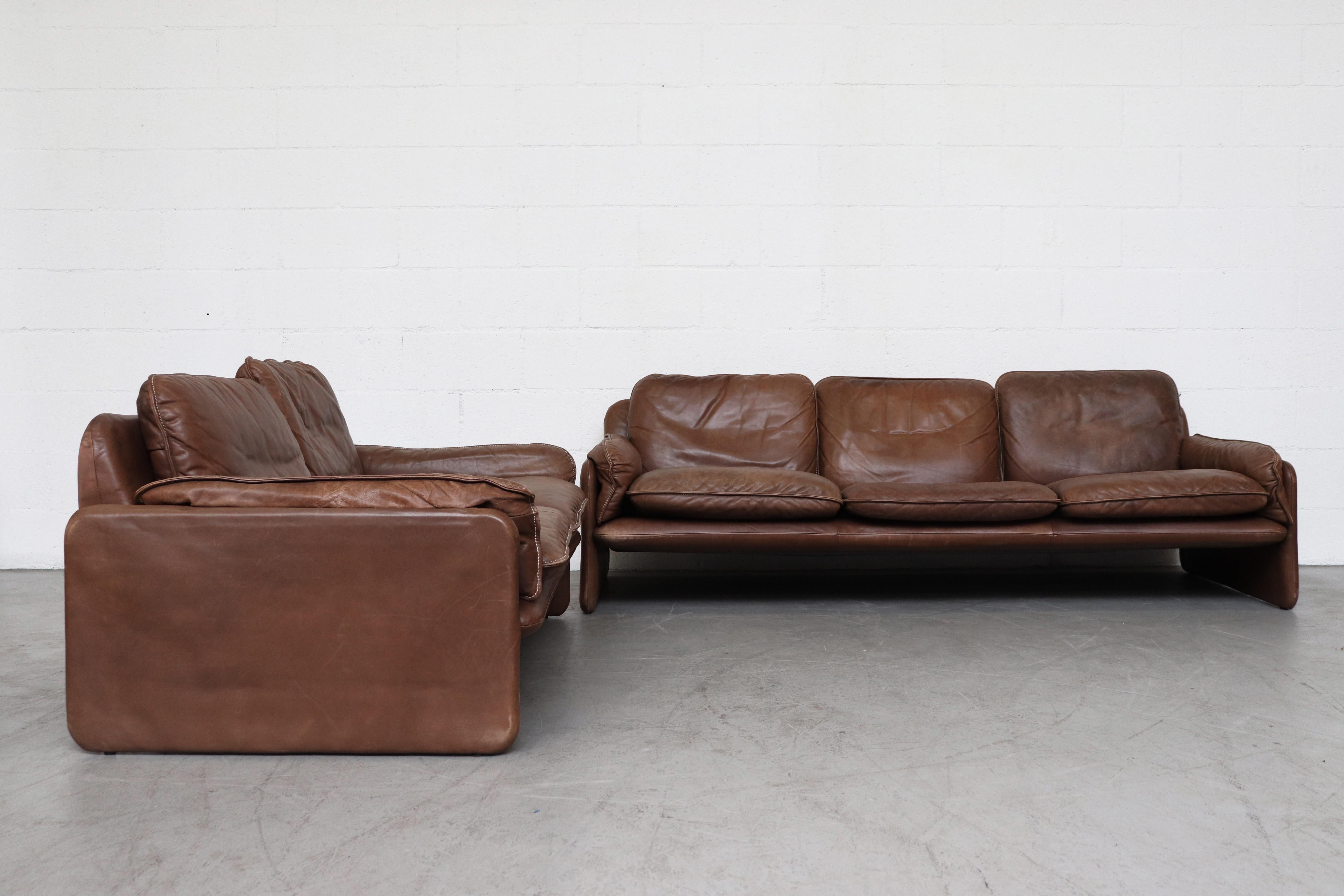 De Sede DS61 brown leather 3-seat sofa with off-white stitching. In original condition with nice patina and visible signs of wear. Small tear at underside of arm rest  near  the seam. Not extremely visible. Wear is consistent with its age and usage.