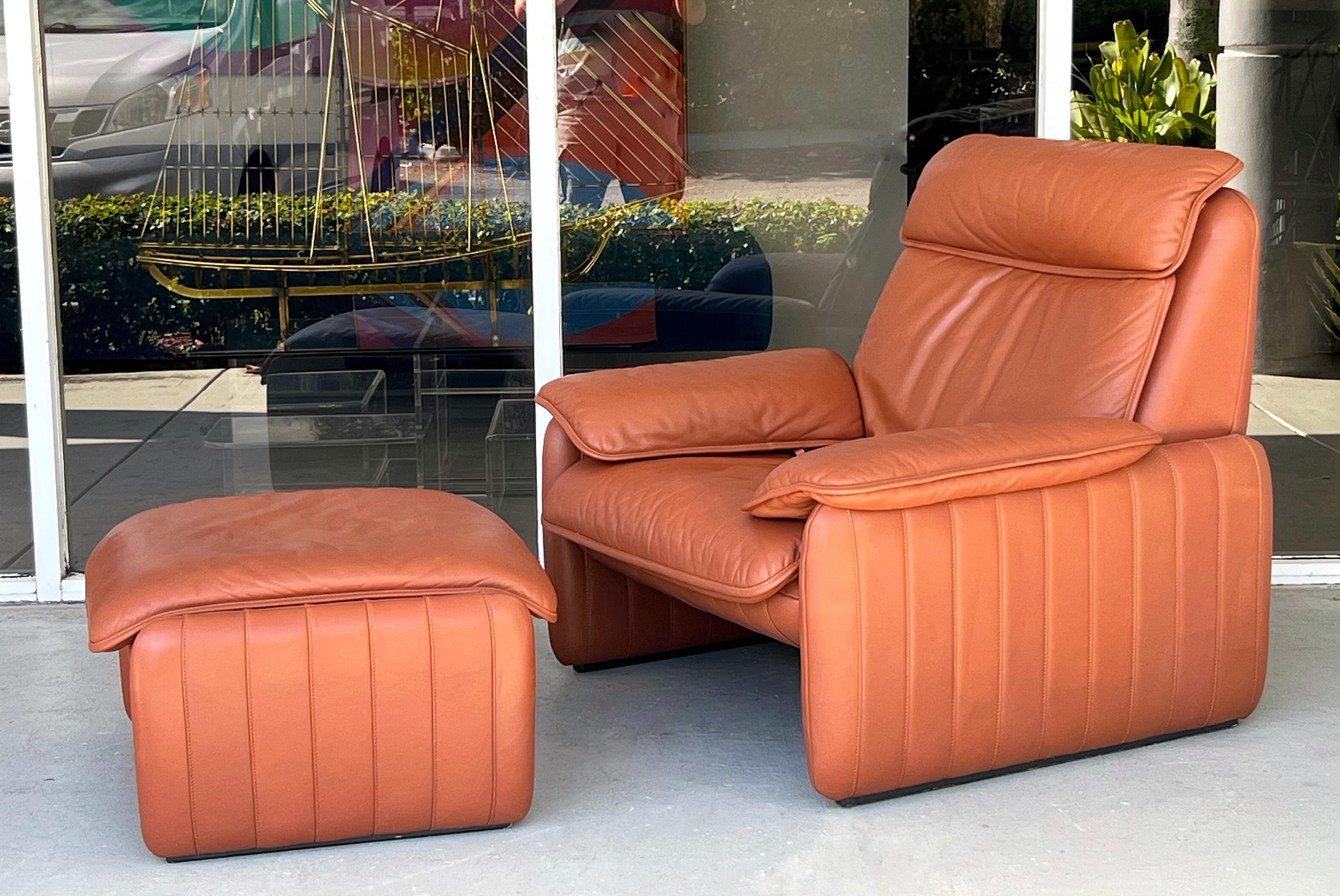 A very comfortable lounge chair and ottoman by premier leather furniture maker De Sede. The chair's back reclines. The design is inviting and plush.