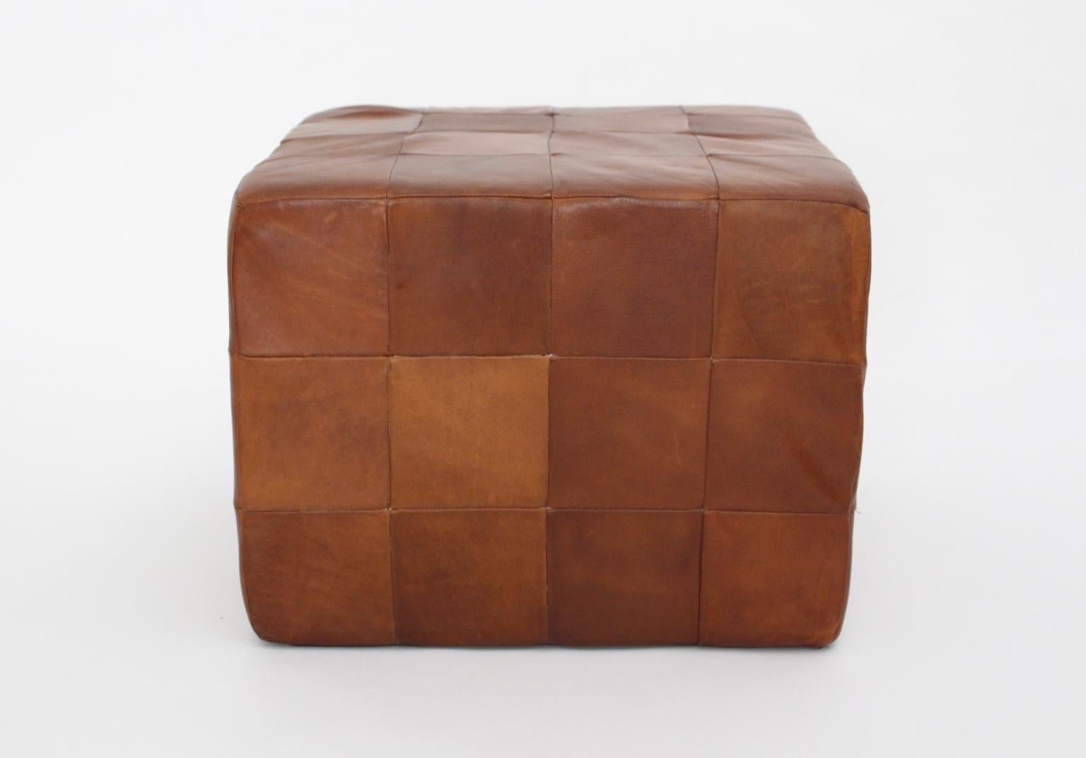 Cubus leather stool by De Sede Switzerland with beautiful leather patina.
Many stitched leather pieces shape this cubus stool.

approx. measures: Width 53 cm
Depth 53 cm
Height 40 cm.