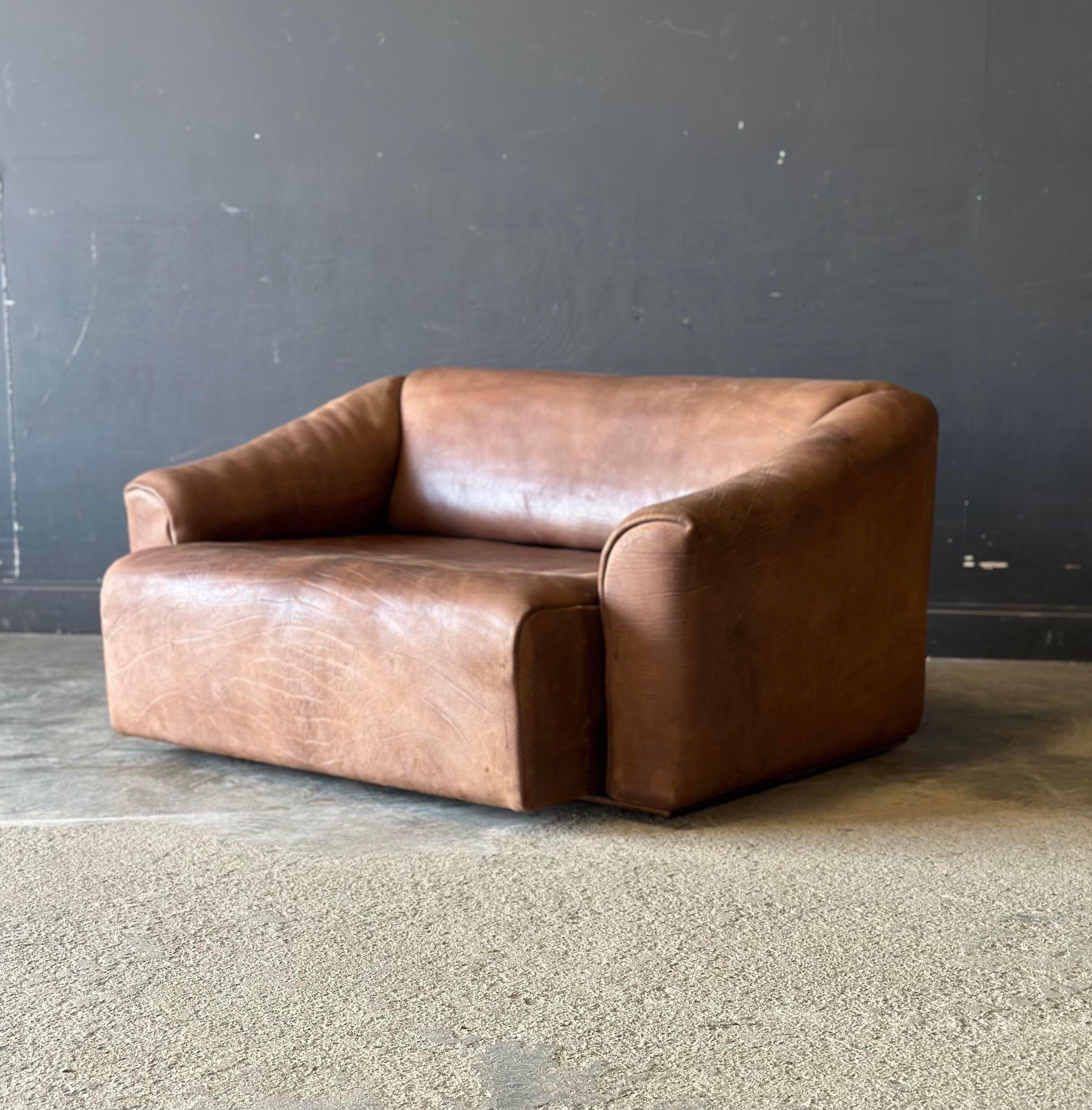 A Swiss De Sede Ds-47 loveseat sofa. An icon of mid century modern design, it is covered in raw uncoated buffalo hide. Extremely soft and comfortable, the sofa extends and reclines.