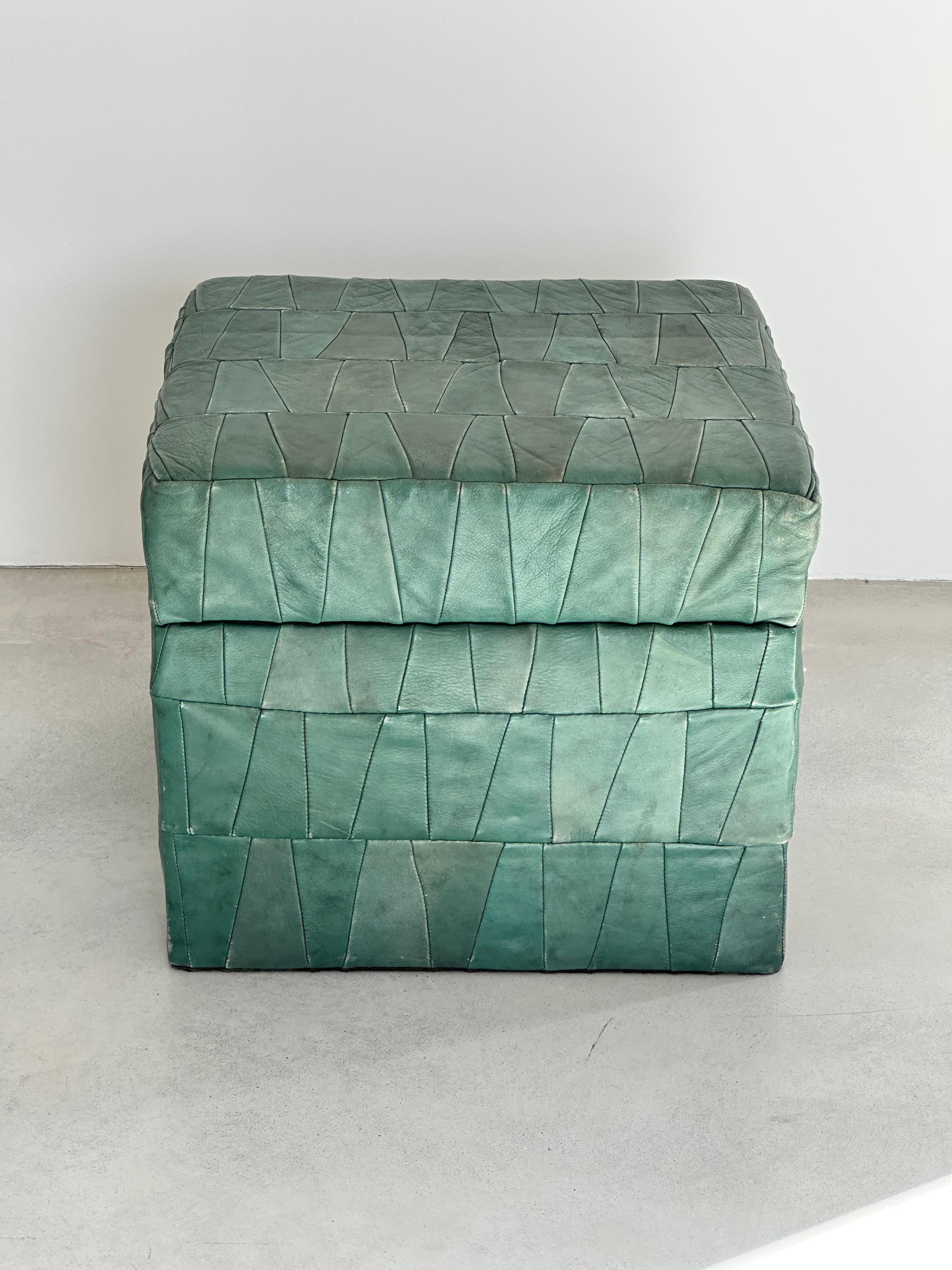 Dark green patchwork leather storage ottomans with open top by Swiss designer De Sede. 

Original soft leather with beautiful patina.

Good condition.

1970s.

Many colors and sizes available, check out my other items.
de Sede has its origins in a