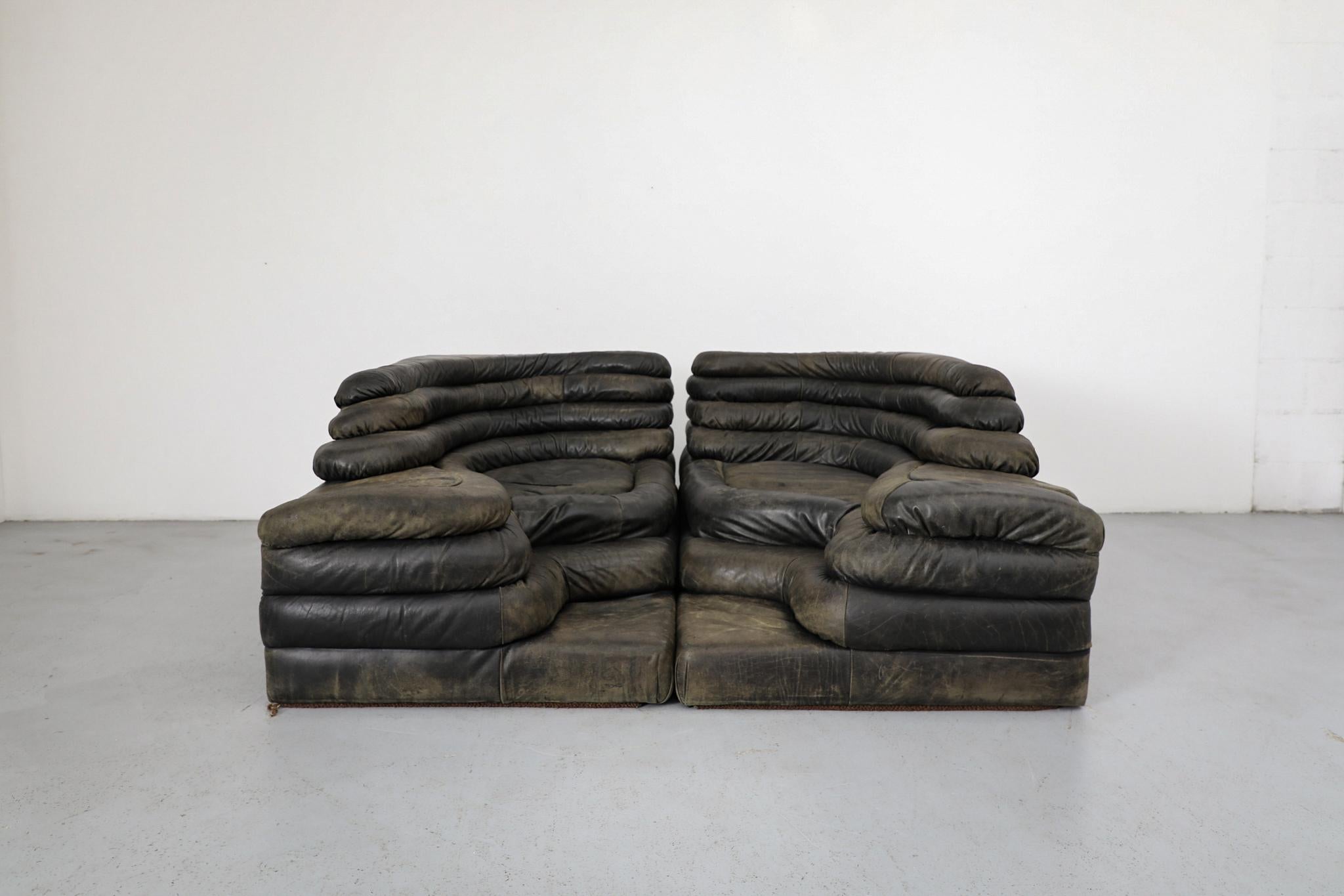 Iconic De Sede 'DS-1025' Terrazza sofas by Ubald Klug, 1970s. Upholstered in rich dark moss green leather. Designed for quintessential Swiss manufacturer De Sede. Its distinctive layered, stepped cushions draw inspiration from natural landscapes,