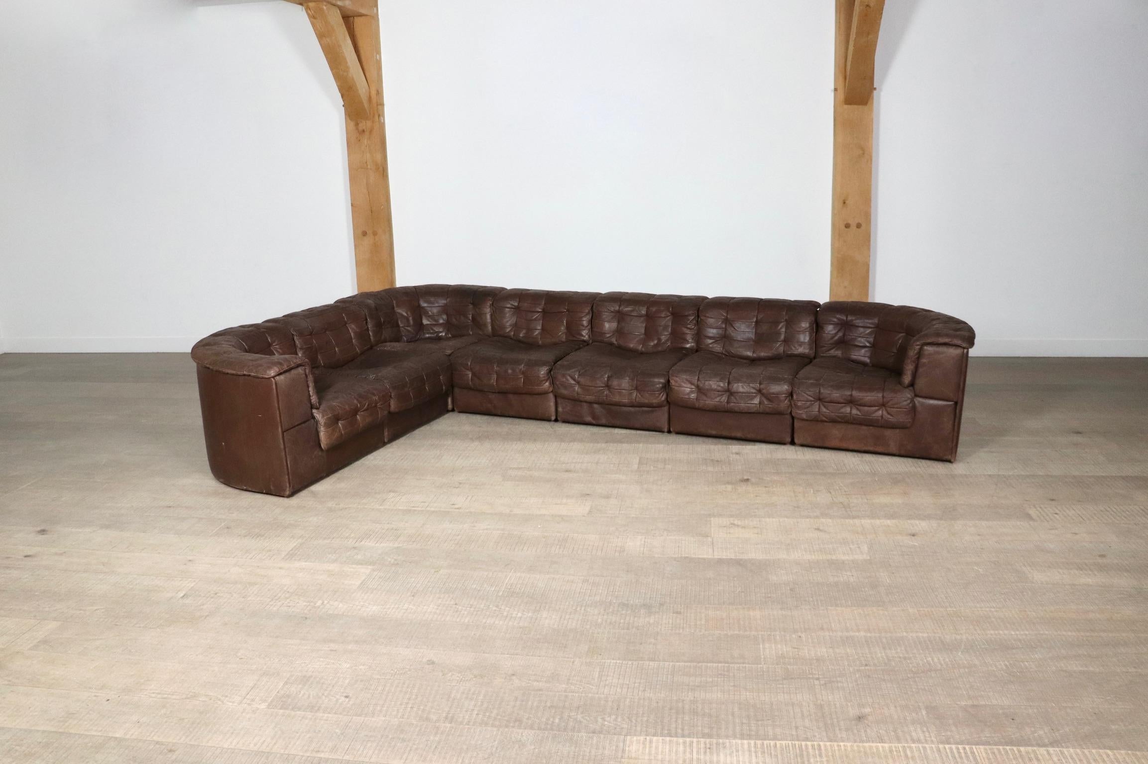 Amazing De Sede DS 11 modular sofa in brown patchwork leather, 1970s. This set consists of seven elements, of which three corners. De Sede is famous for its high quality, for which this sofa is the perfect example! The use of only the best materials