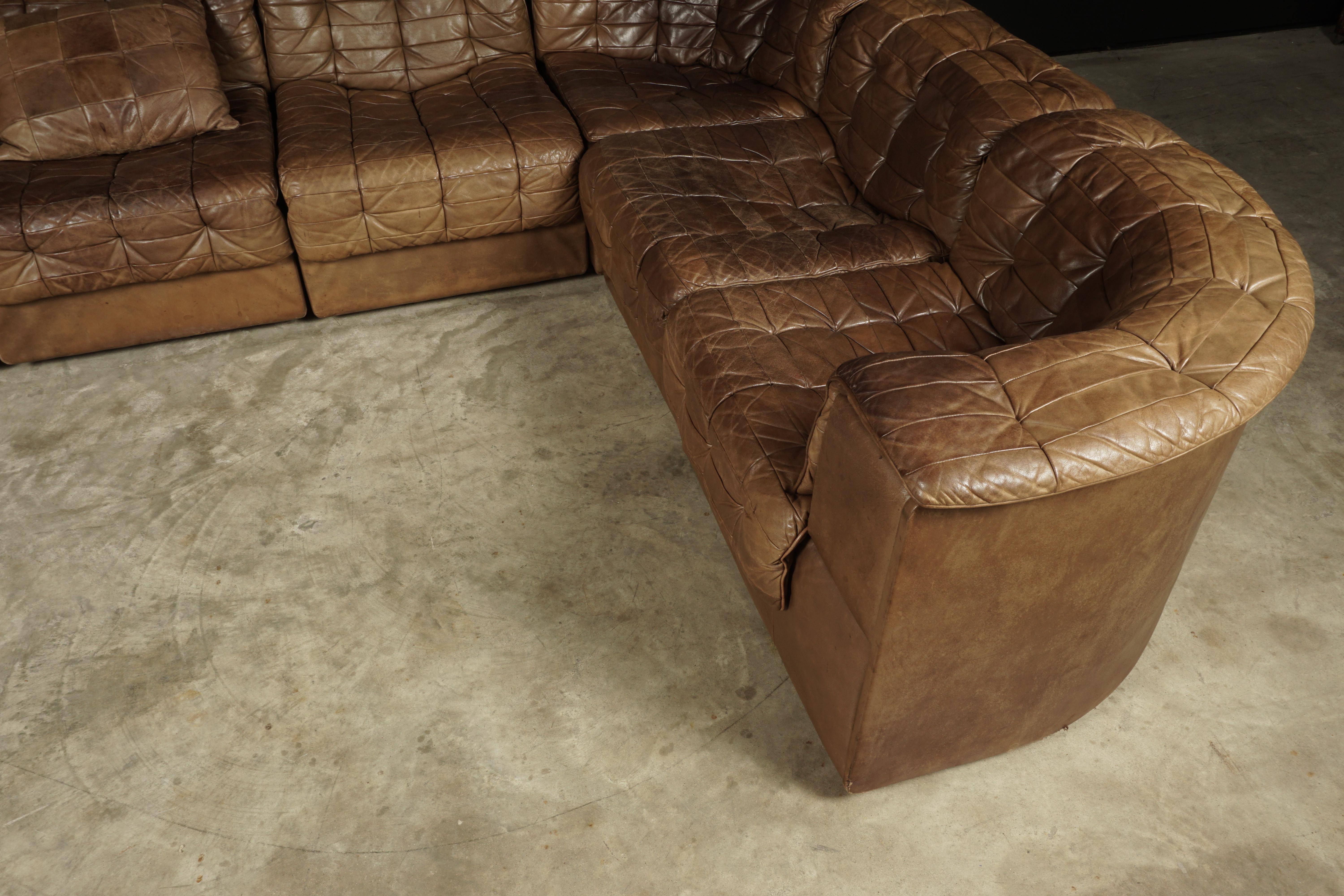 De Sede Ds 11 Sectional Patchwork sofa in Cognac Leather, 1970s. Six modular pieces that can be arranged to your wishes. Manufactured by De Sede in Switzerland. Leather with great wear and patina. Corner element measures: 
D - 32.5
H - 24.5
W -