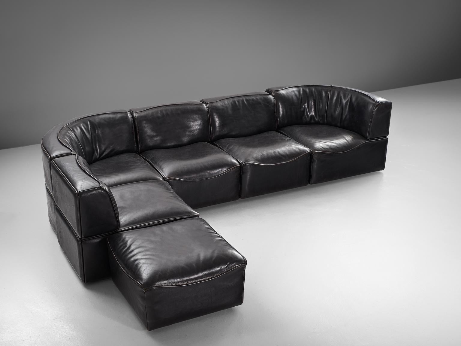Sectional sofa model DS-15, black leather by De Sede, Switzerland, 1970s. 

This high quality sectional sofa contains two corner elements, three normal elements and one ottoman, which makes it possible to arrange this sofa to your own wishes. The