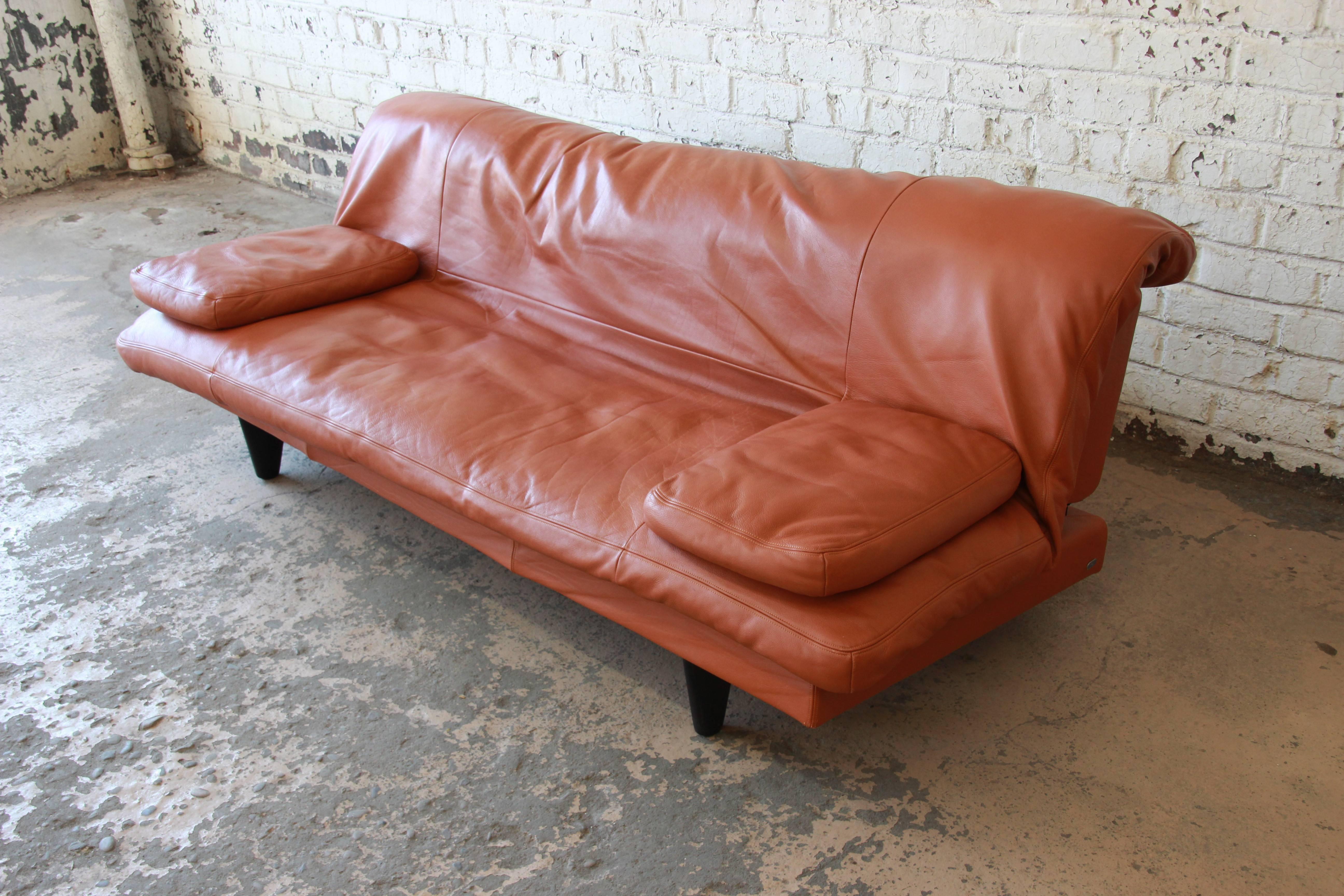 Offering an exceptional sofa or daybed by Ernst Ambühler for De Sede of Switzerland, circa 1970s. The sofa features gorgeous light brown leather, with a removable mattress cushion and two loose pillows. It is cleverly designed to easily convert from