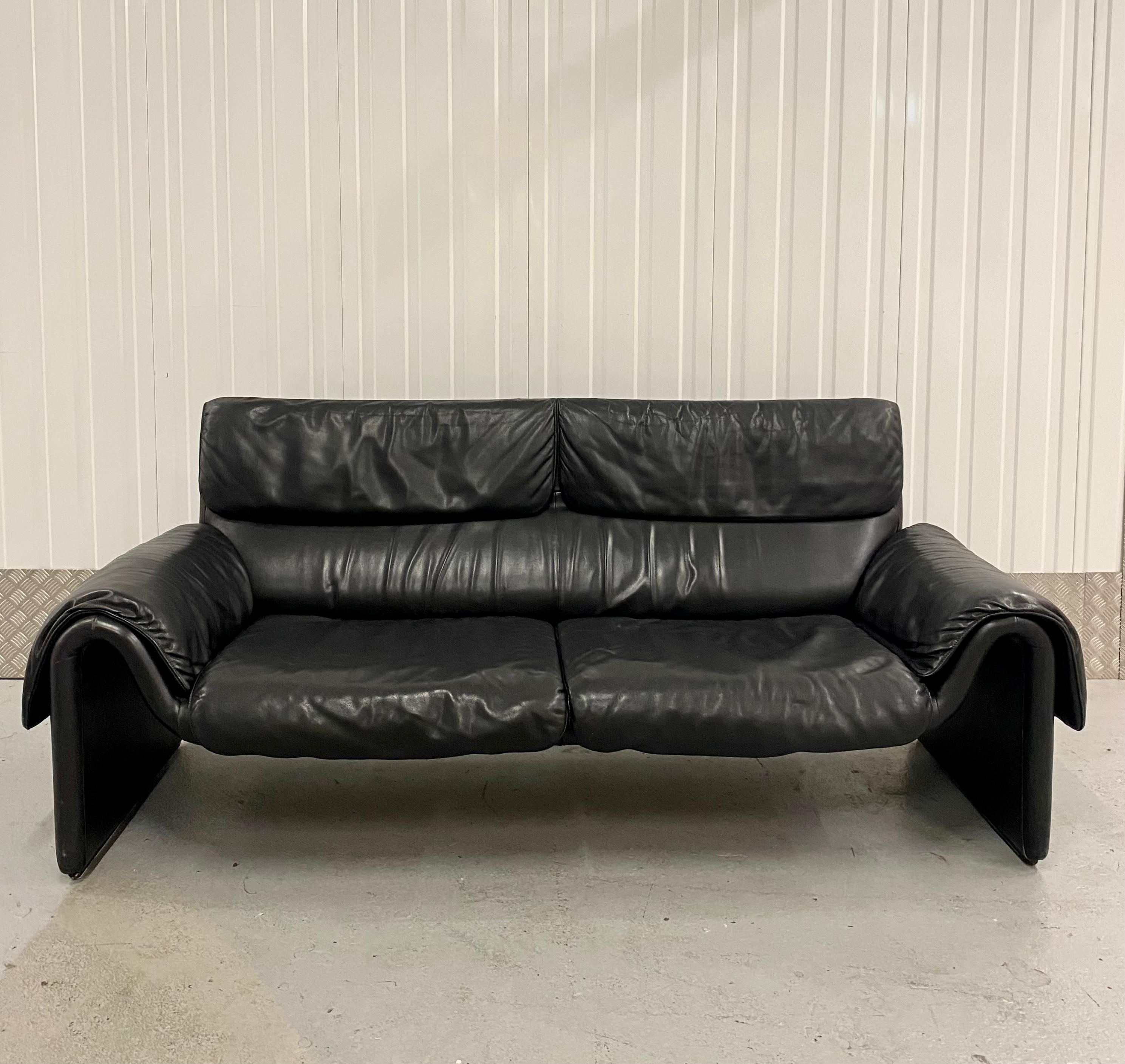 Stunning design with organic forms manufactured by De Sede Switzerland circa 1980-1989. The black leather sofa remains in good condition, with normal wear consisting it’s age and use. Signed, gorgeous timeless design!