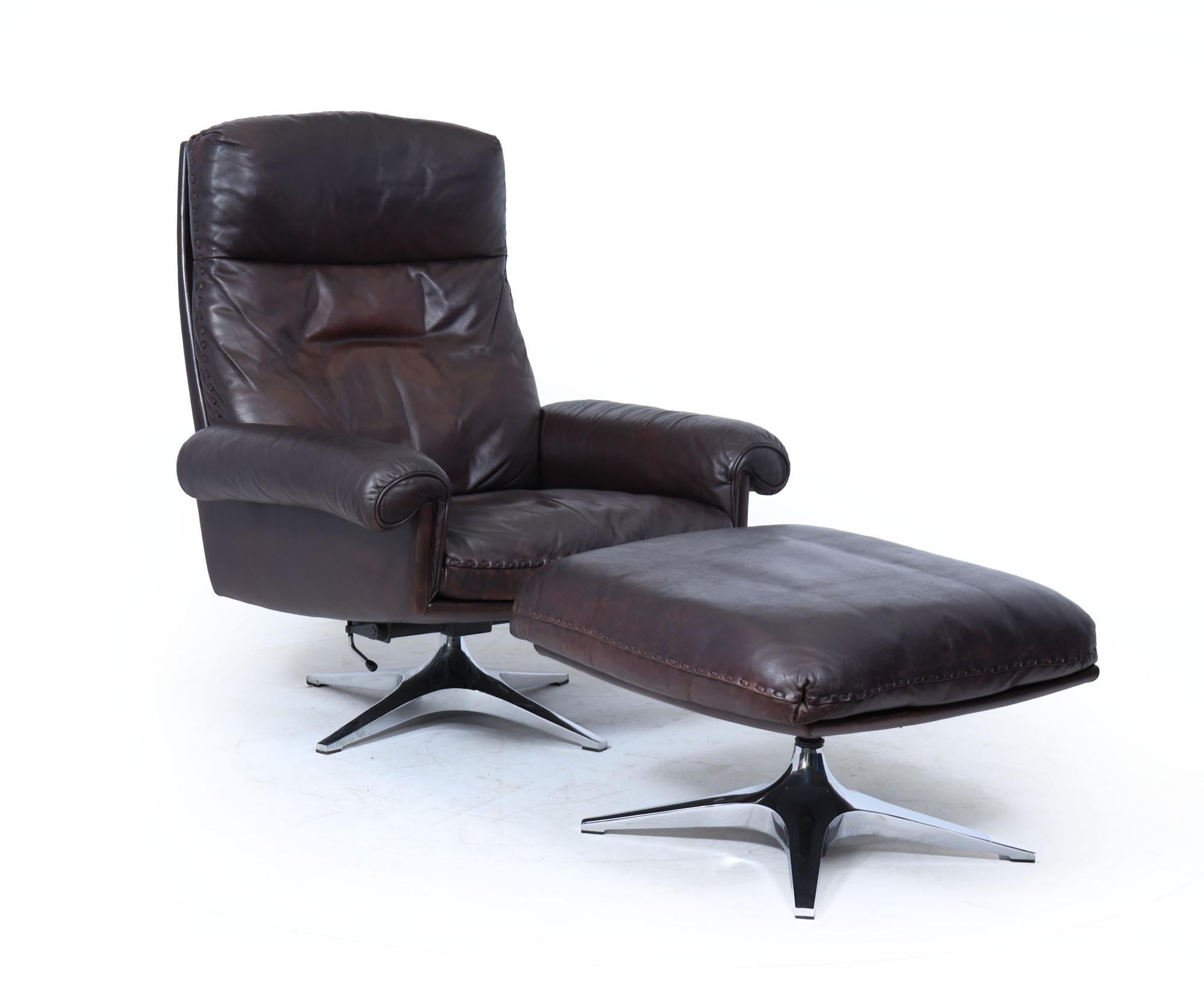 De Sede DS-31 Armchair and Footstool 
An iconic Swiss design by De Sede, this DS-31 reclining armchair and matching footstool offer the perfect blend of luxury, ergonomics, and timeless style. Upholstered in supple, dark brown leather with a rich