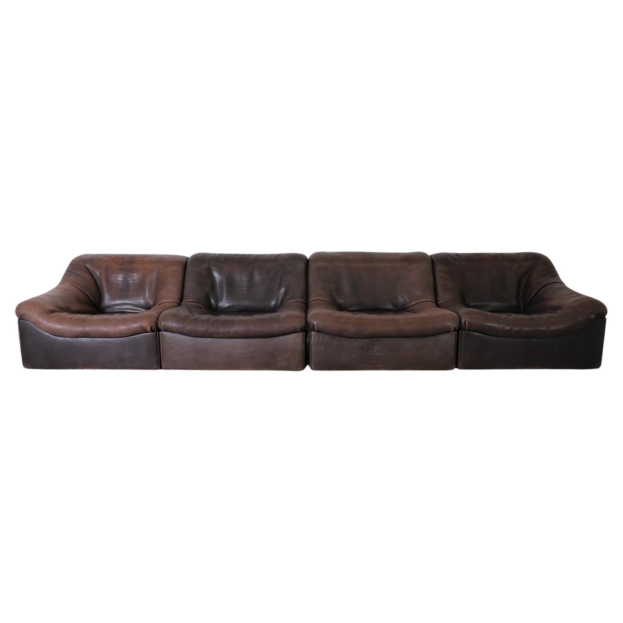 Simply Incredible, 1970's 'DS-46' modular sofa by De Sede. A gorgeous four-section sofa upholstered in thick dark buffalo leather. Heavy individual pieces that can be re-positioned and re-arranged to compliment any living space while providing a
