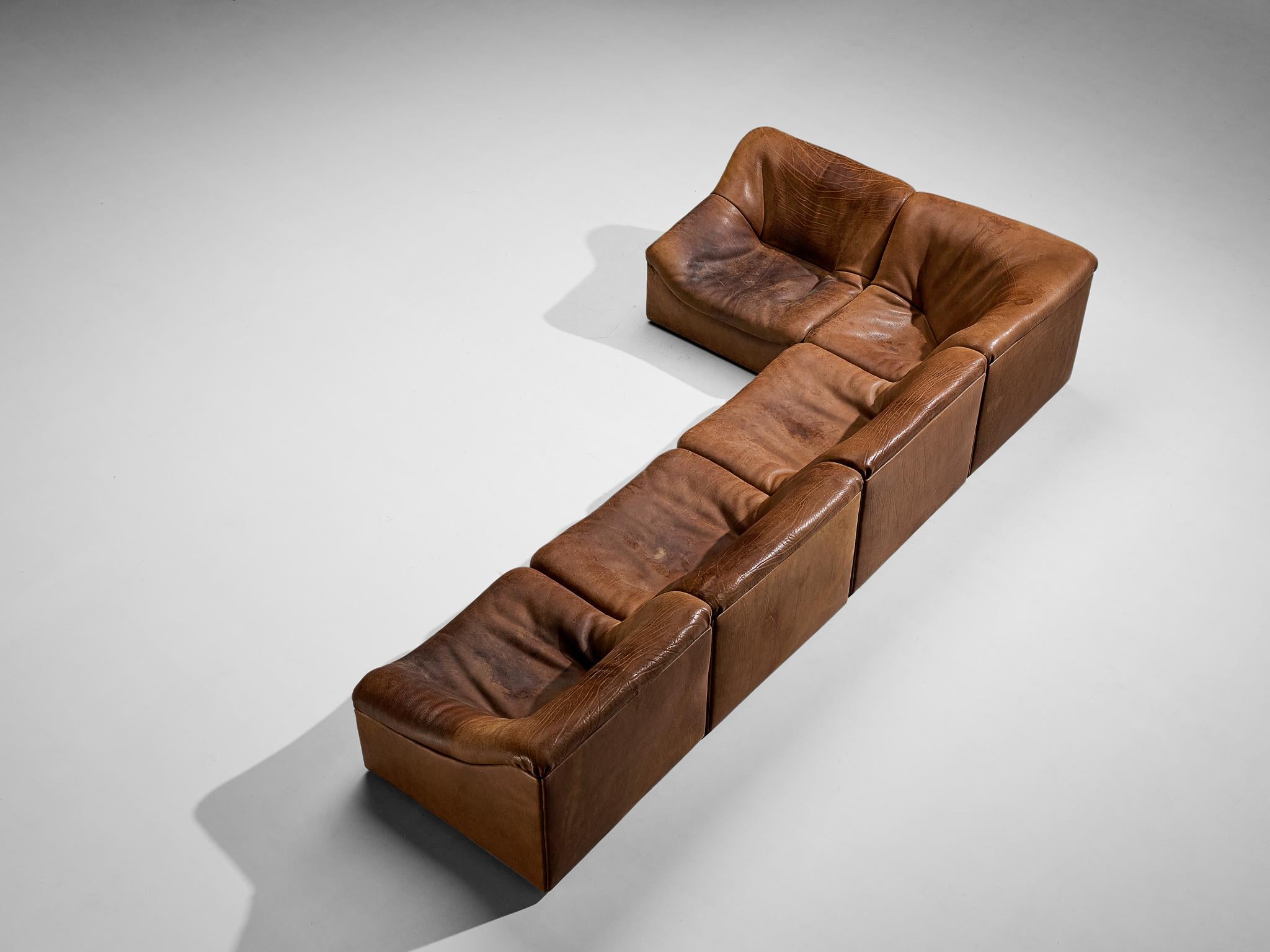 De Sede, 'DS 46' sectional sofa, heavily patinated cognac buffalo leather, Switzerland, 1970s.

Comfortable modular sectional sofa consisting out of five elements in thick buffalo leather by De Sede. This model features a solid base with a