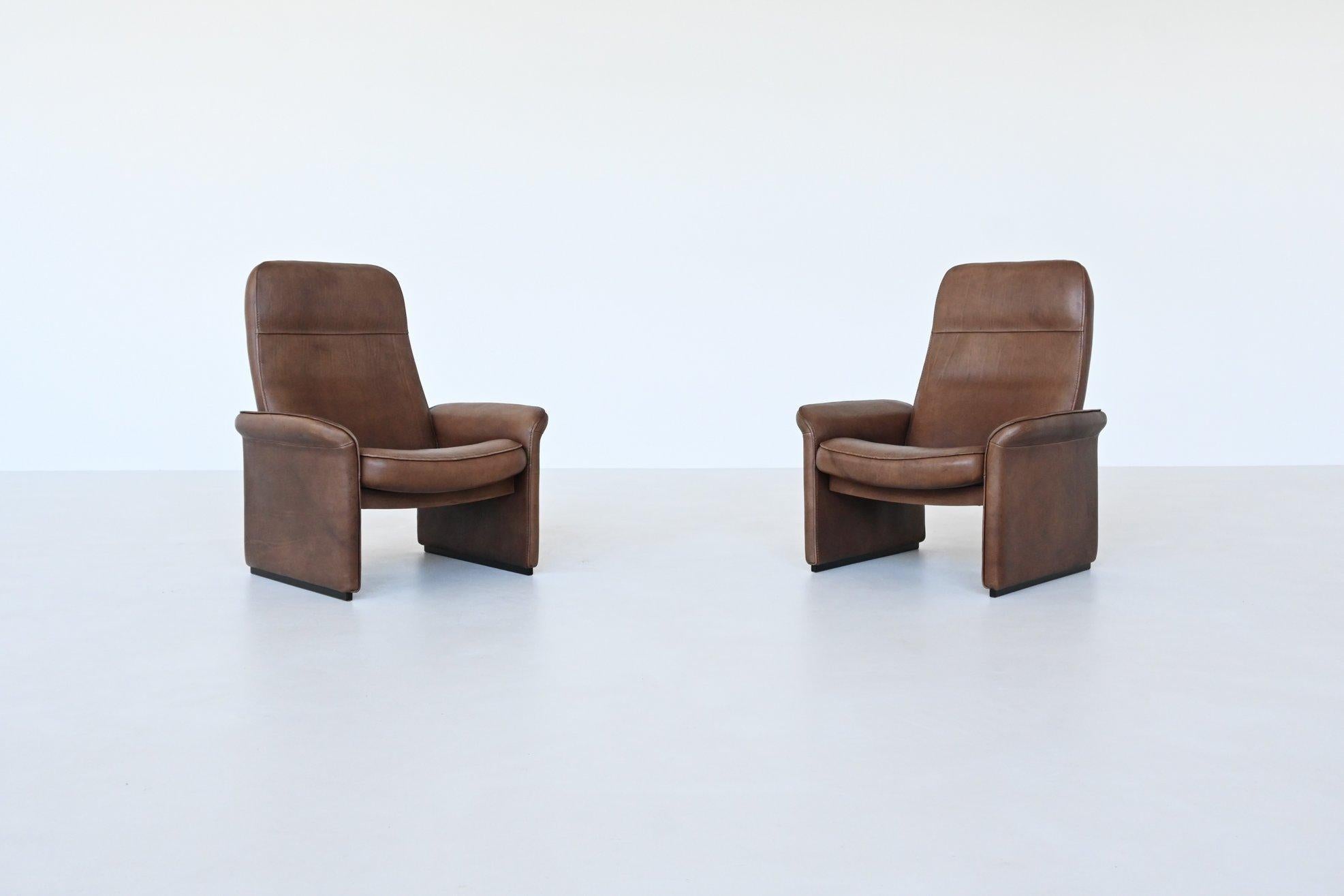 Very nice lounge chairs model DS 50 designed and manufactured by De Sede, Switzerland 1970. This pair exemplifies the brand's commitment to quality and comfort. Made from luxurious brown buffalo leather, these chairs are both sumptuous and stylish,