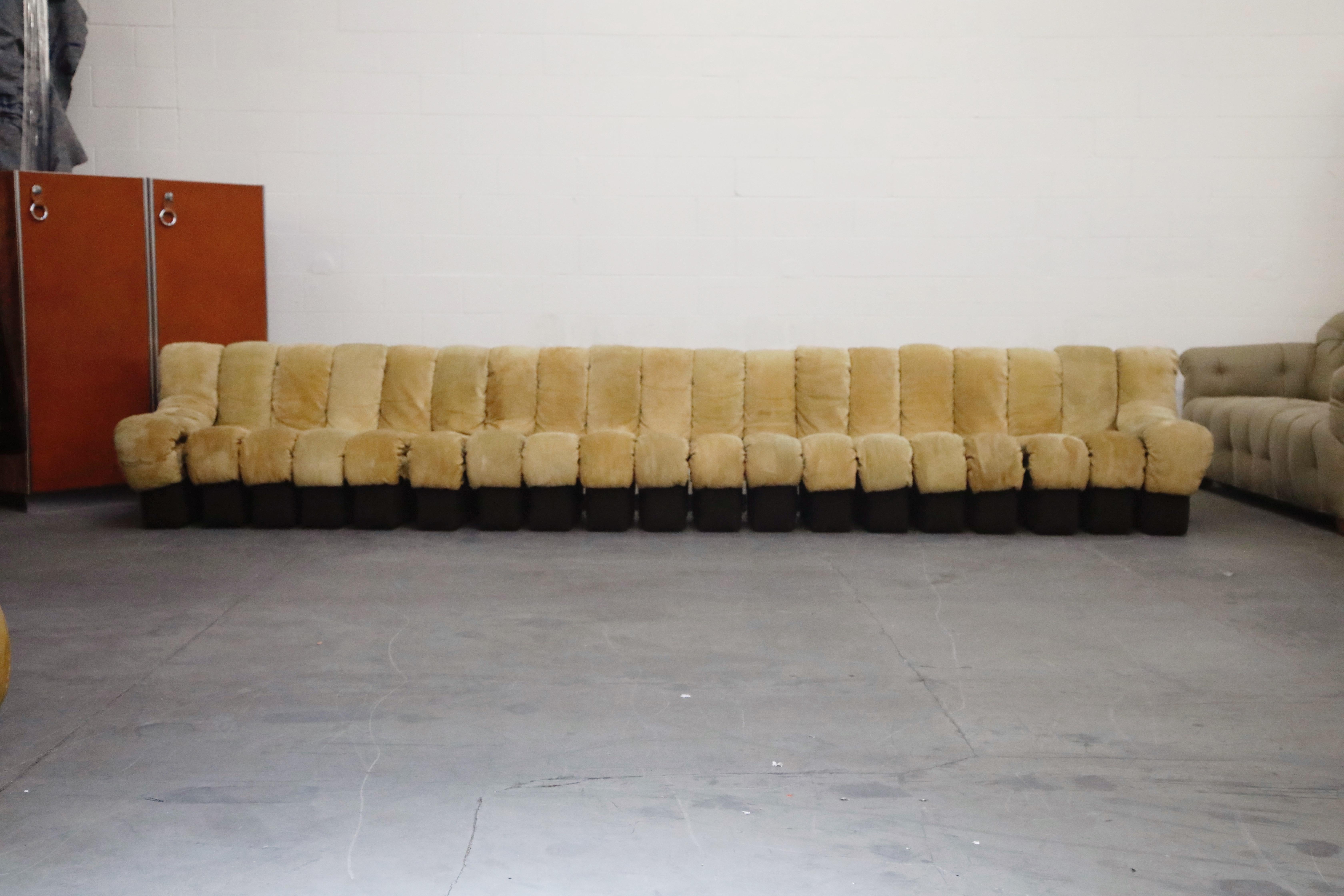 This classic 'Non-Stop Sofa' by Swiss maker De Sede in a distressed tan suede is priced low to allow you to either use as-is in its moderately distressed condition or reupholster to a new fabric or leather of your choosing. Most sections are signed